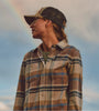 Woman Standing in Front of a Rainbow Wearing a Faherty Brand Legend Sweater Shirt Flannel