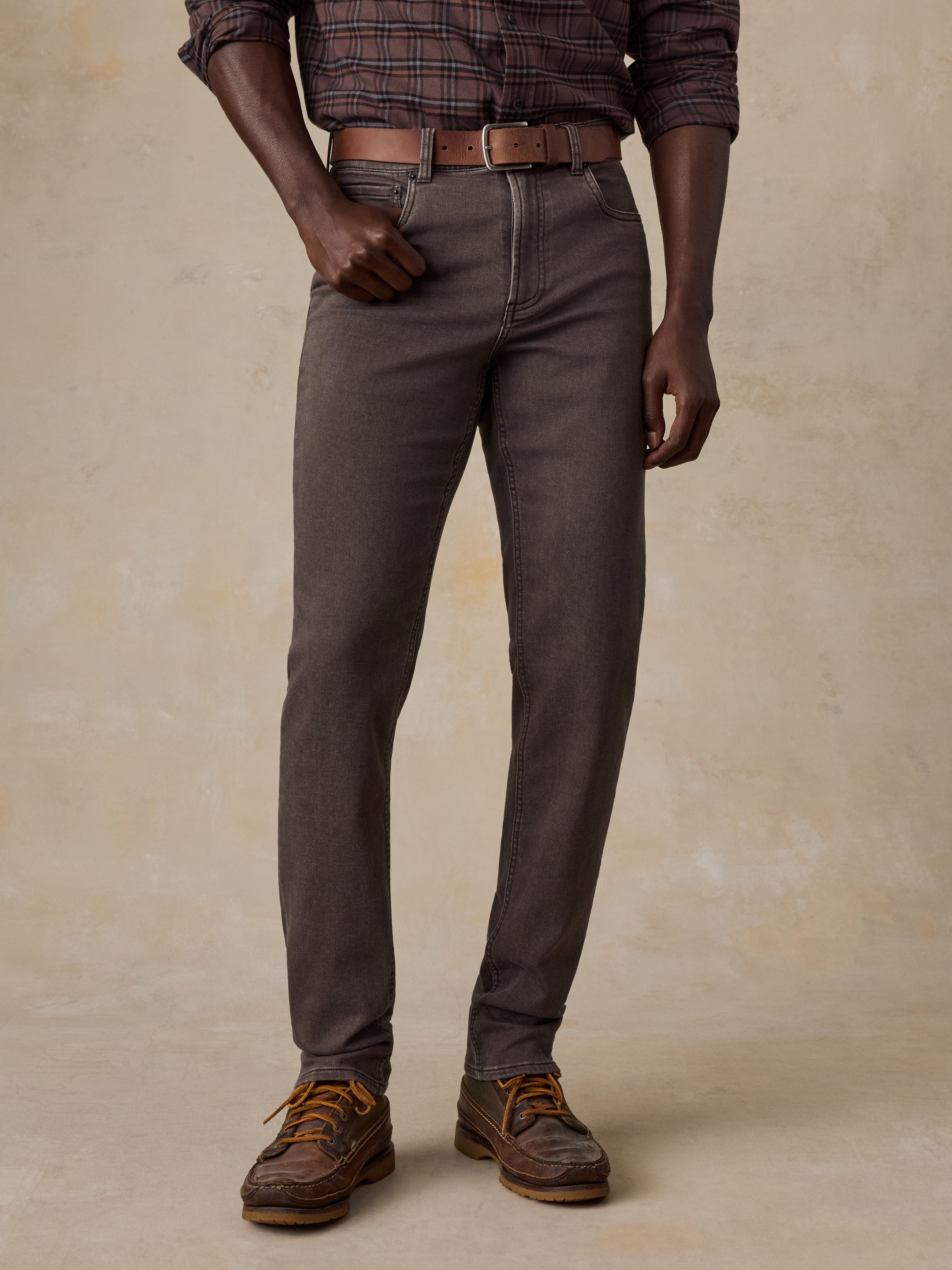 Man wearing a brown plaid shirt and brown pants