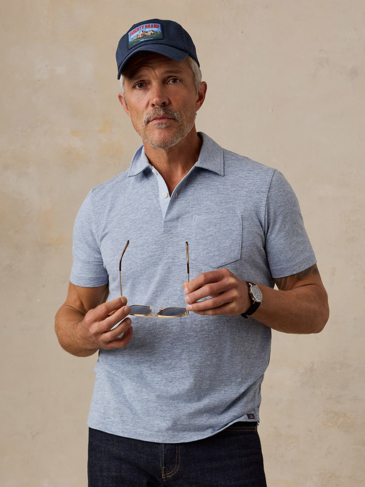 A man wearing a light blue polo, image 1 of 5