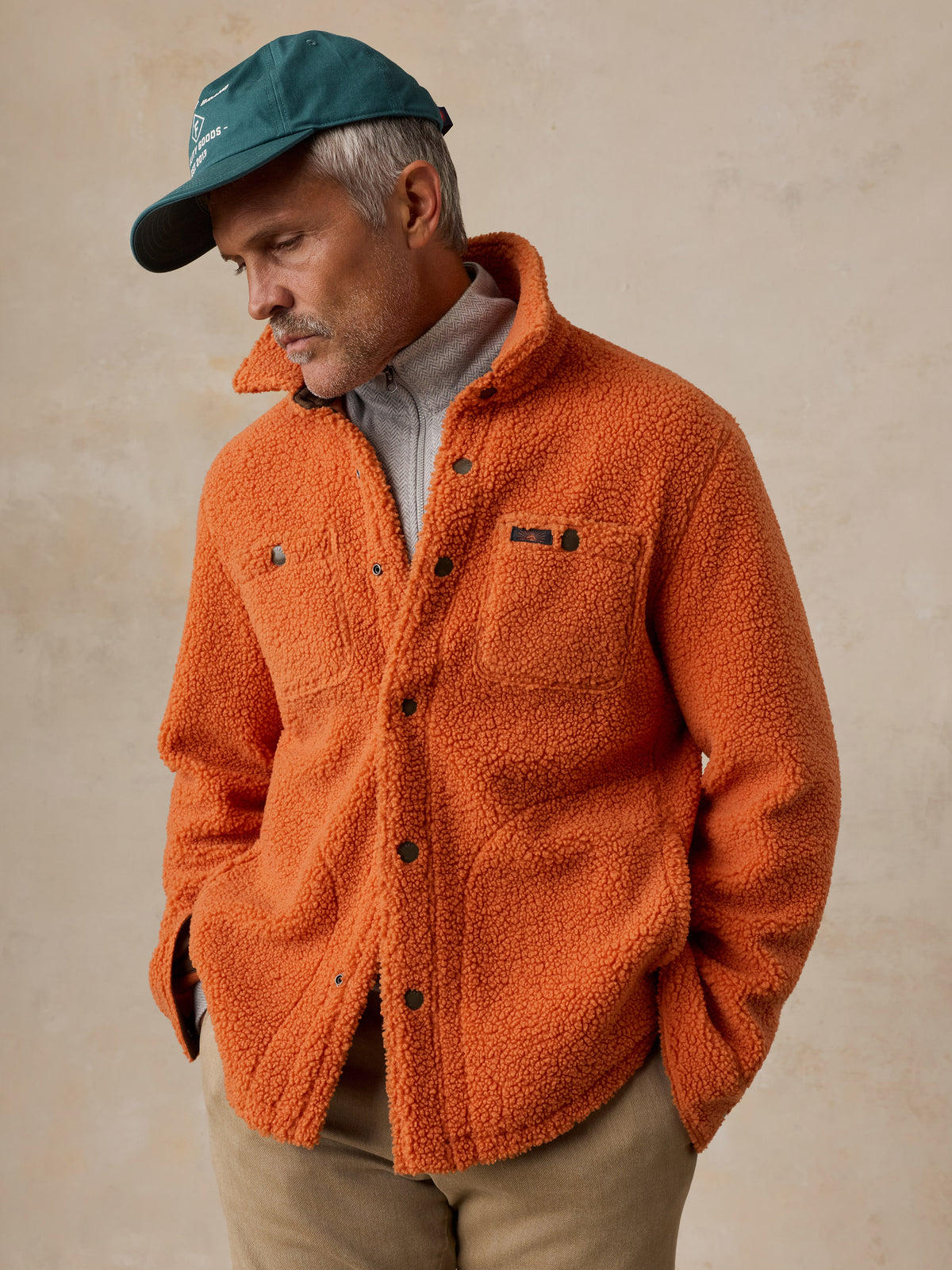 A man wearing an orange fleece , image 6 of 6