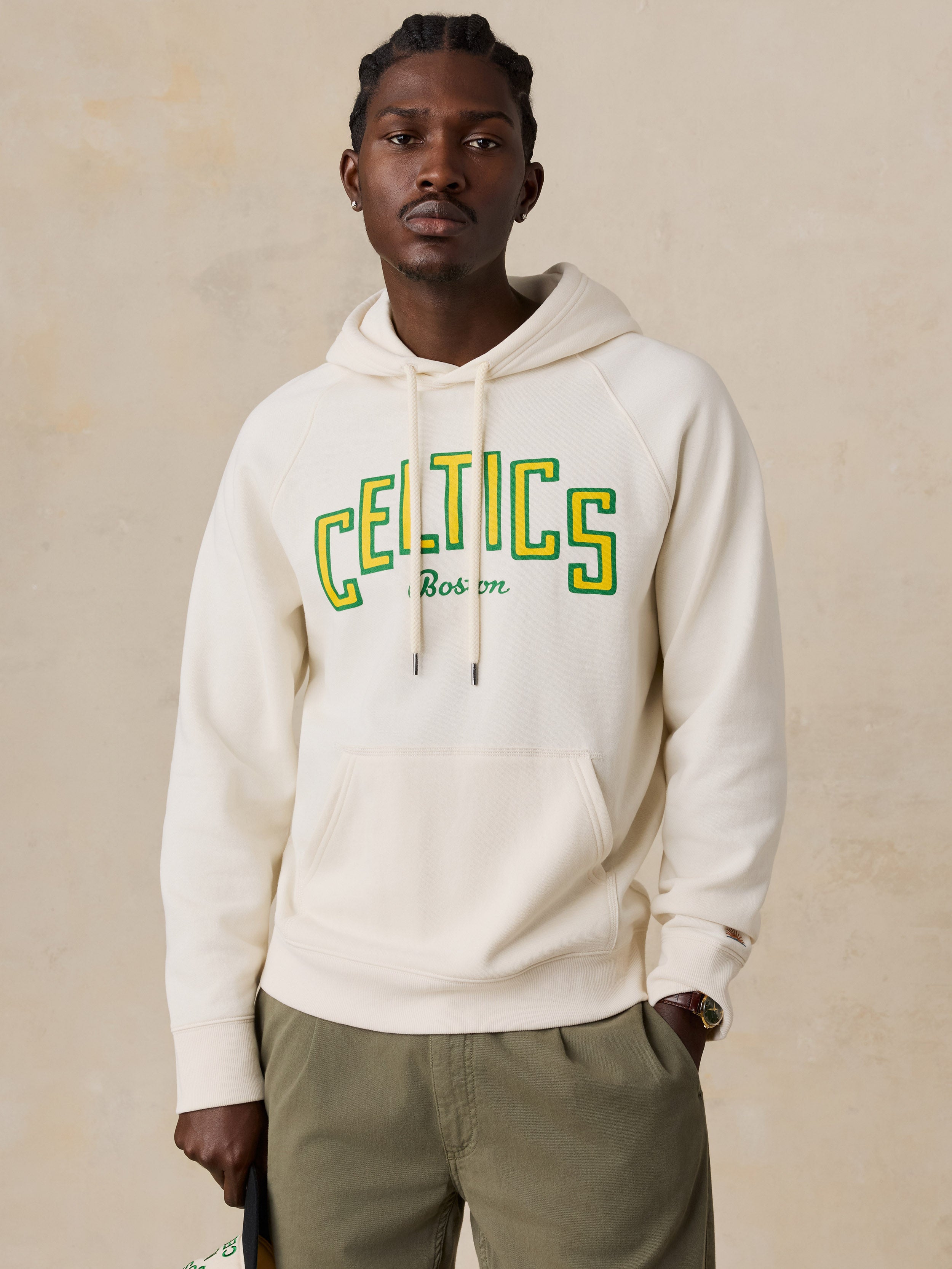 A man wearing a white Boston Celtics hoodie