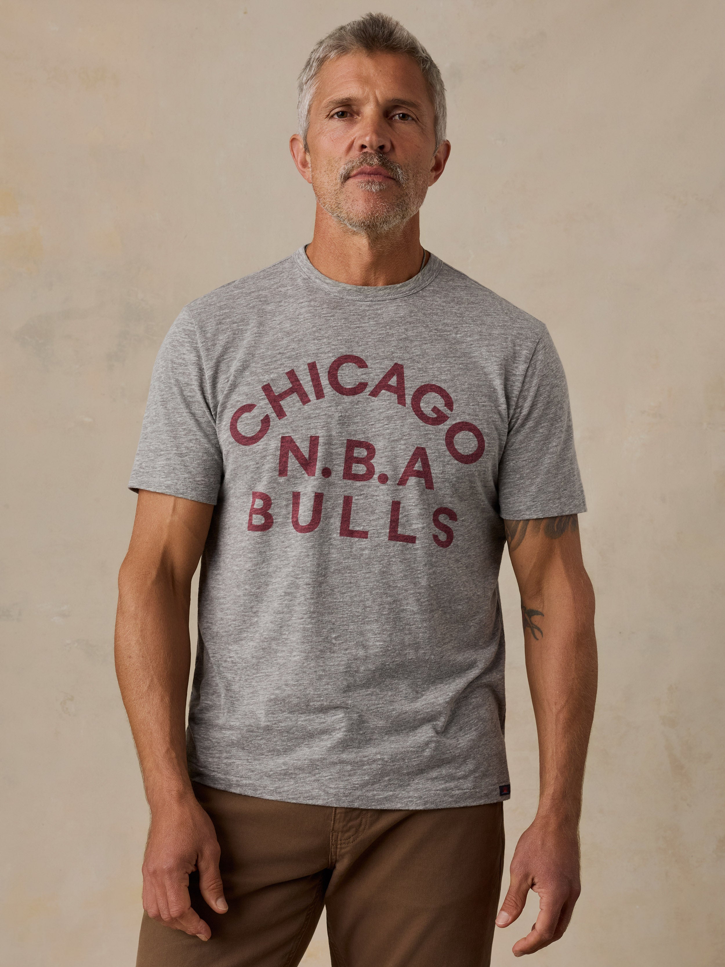 A man wearing a grey Chicago Bulls tee