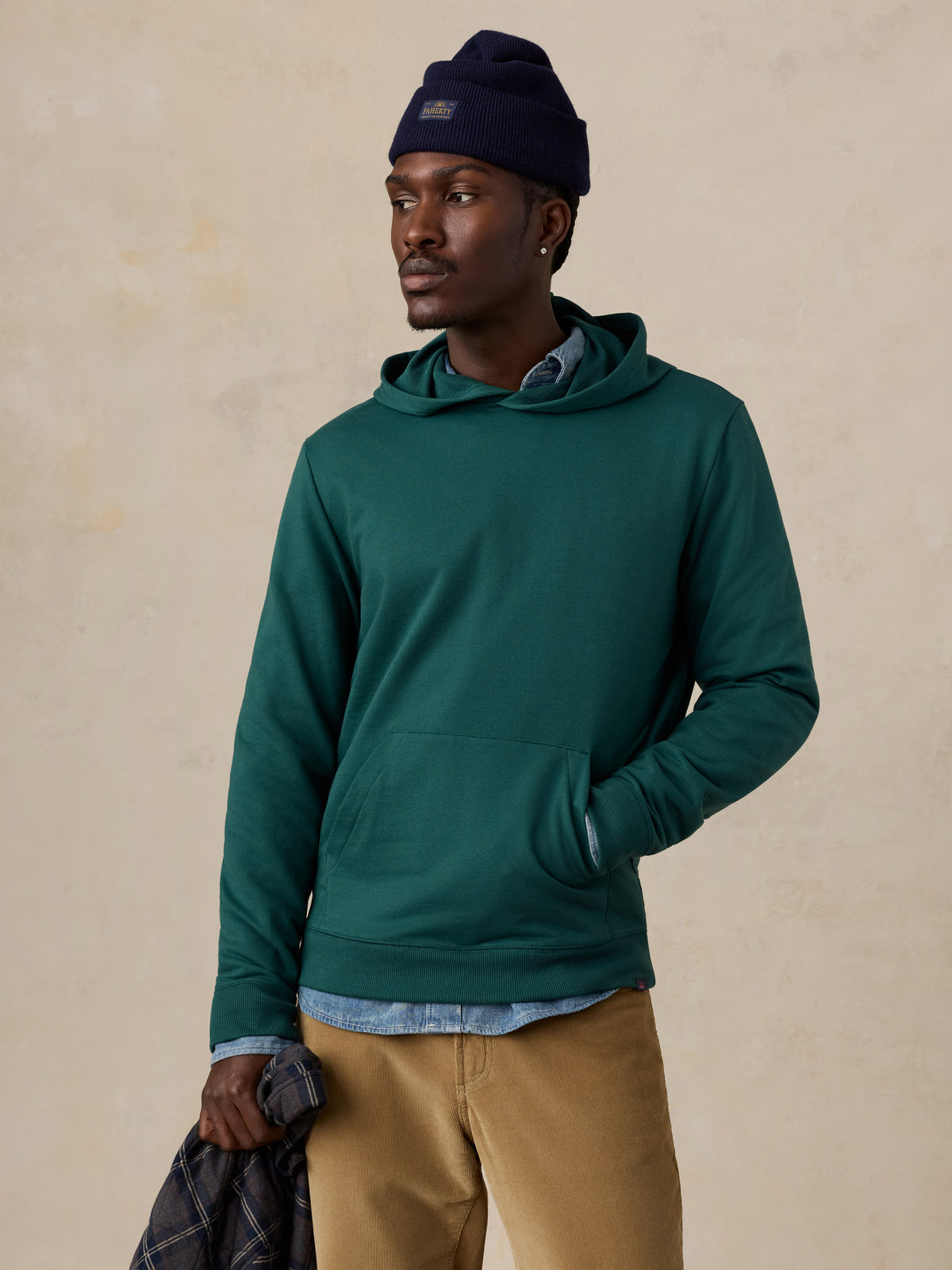 A man wearing a teal hoodie , image 1 of 6