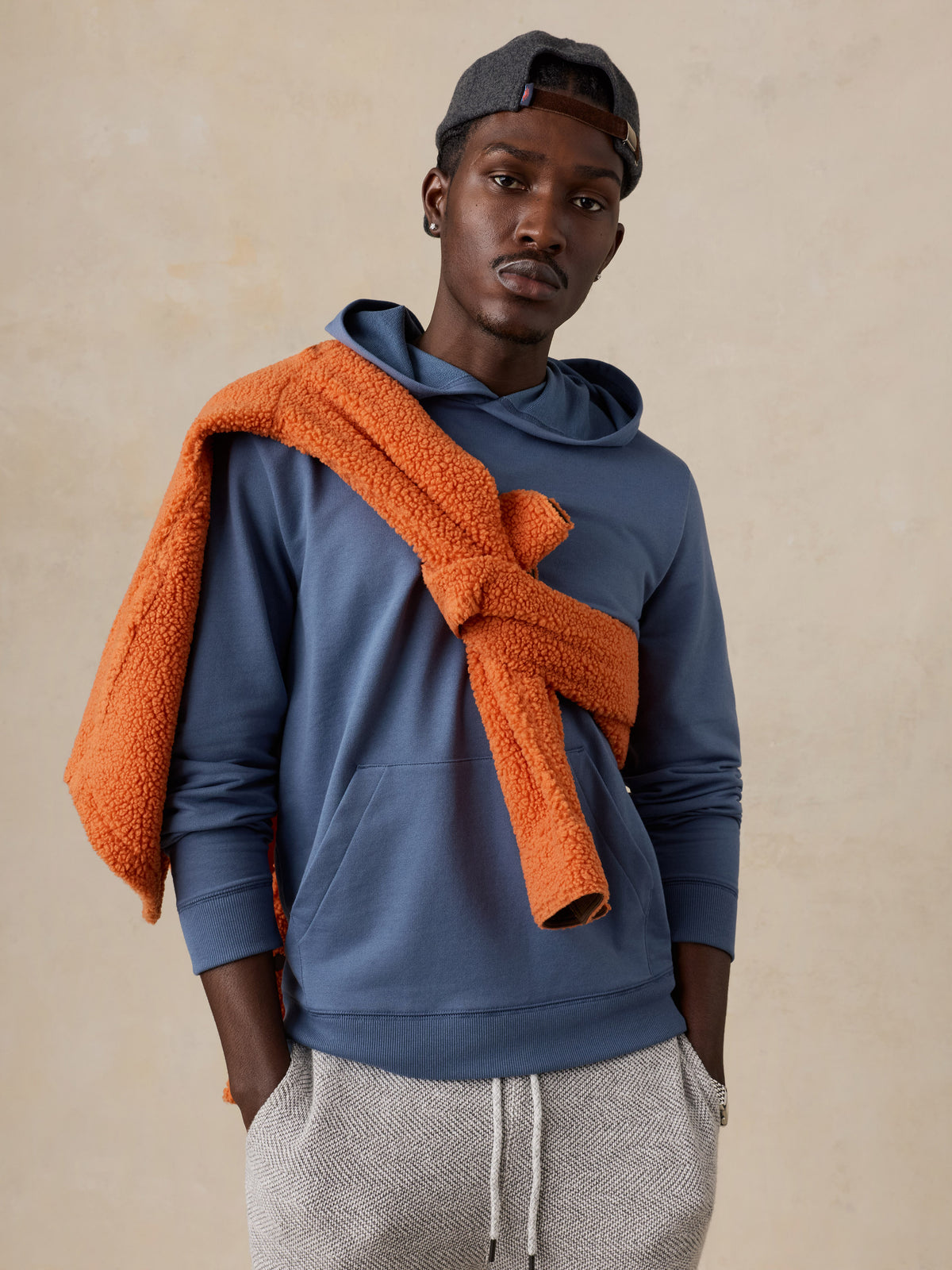 A man wearing a blue hoodie , image 2 of 5