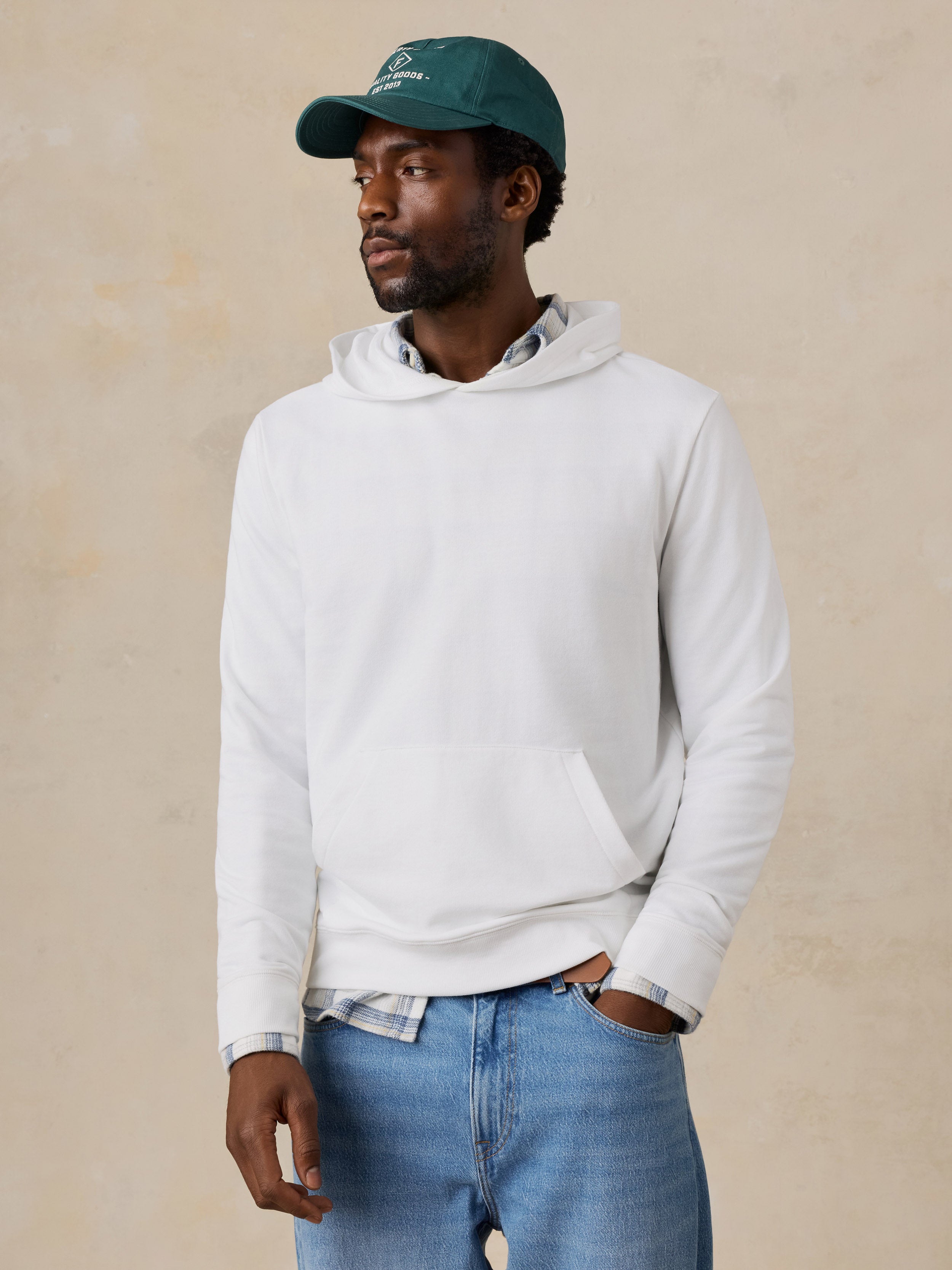 A man wearing a white hoodie