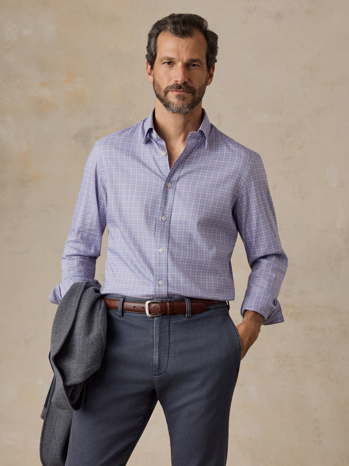 Man wearing a light purple plaid shirt and chino pants, image 1 of 5