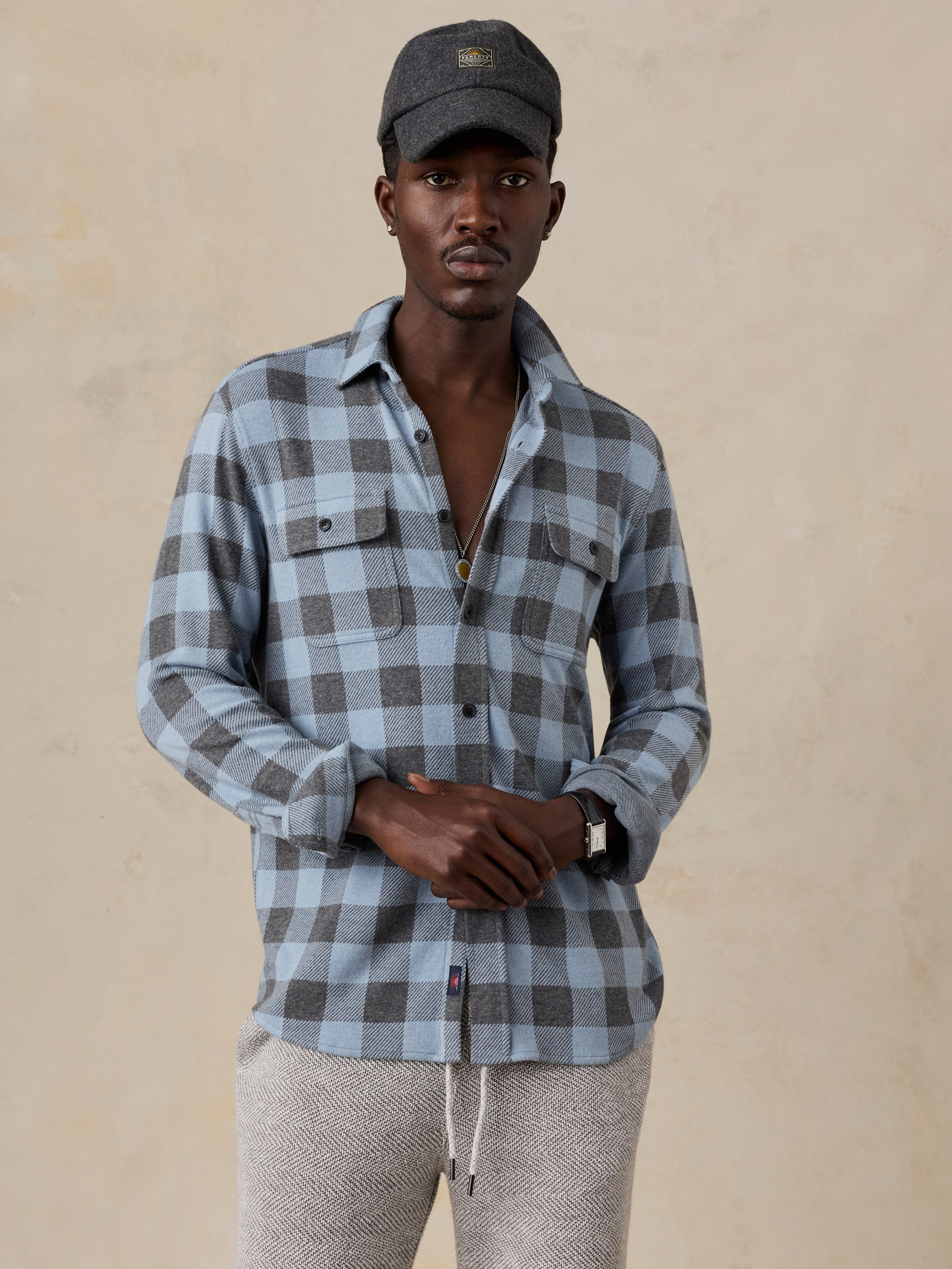 A man wearing a blue plaid shirt