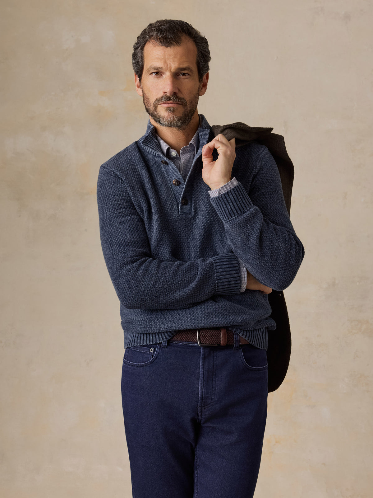 Man wearing a blue button up sweater and navy pants, image 1 of 5