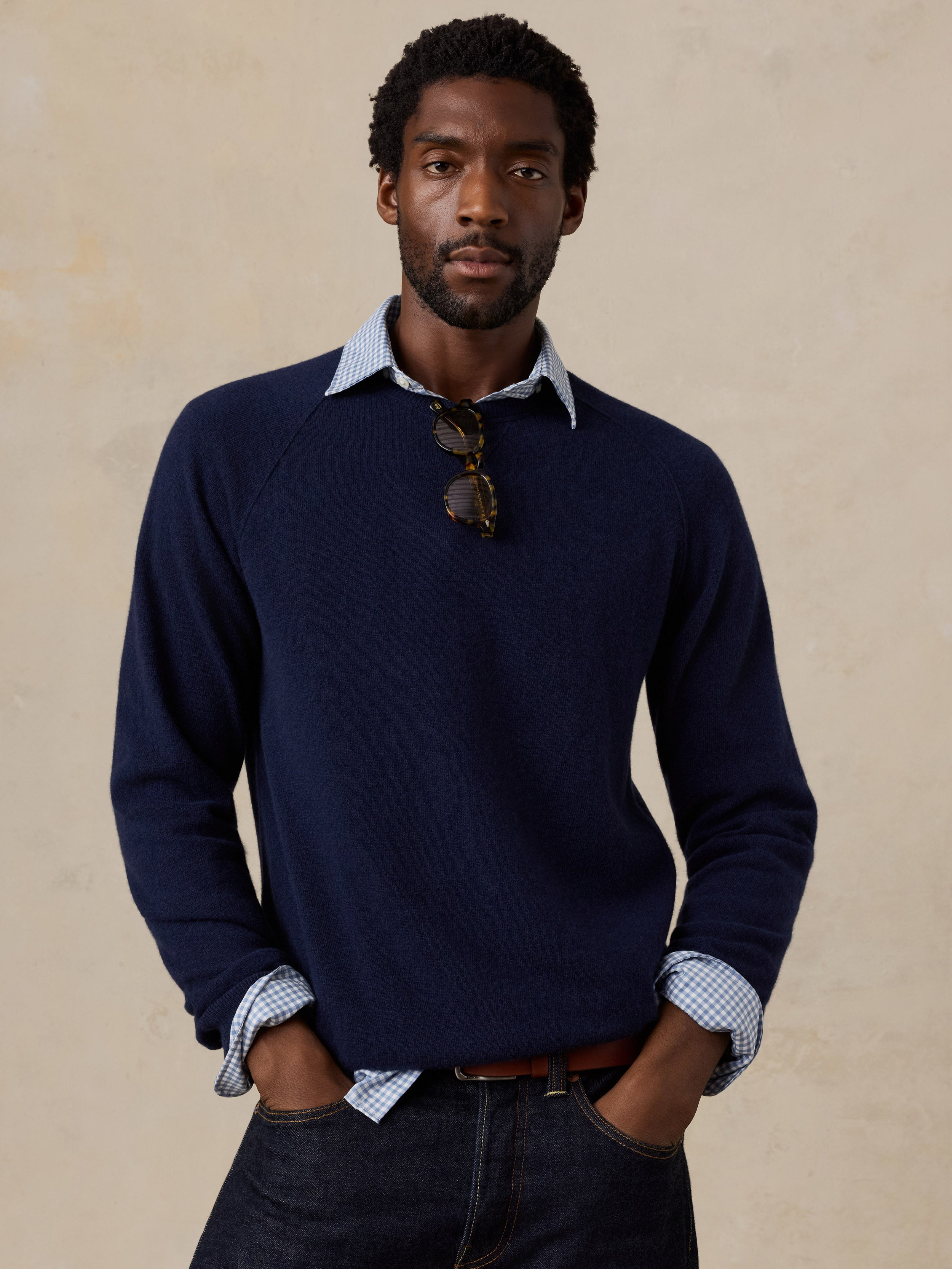 A man wearing a blue crewneck