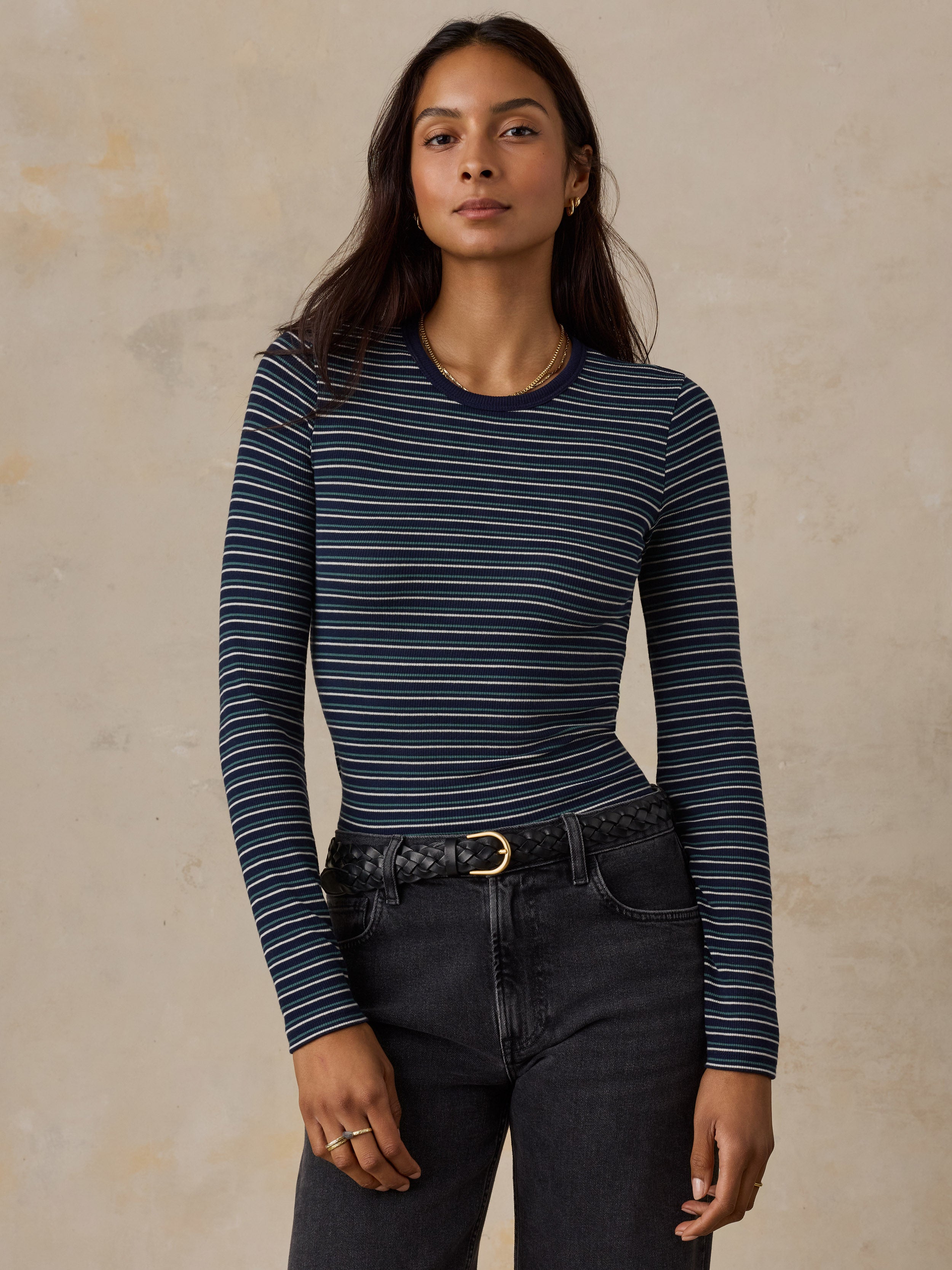 A woman wearing a blue striped shirt and jeans