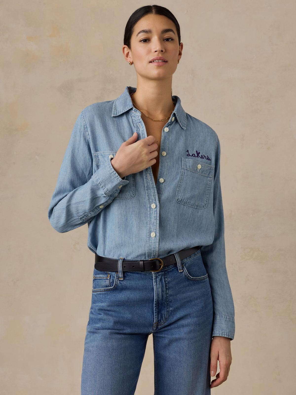 A woman wearing a LA Lakers chambray shirt and jeans, image 1 of 6