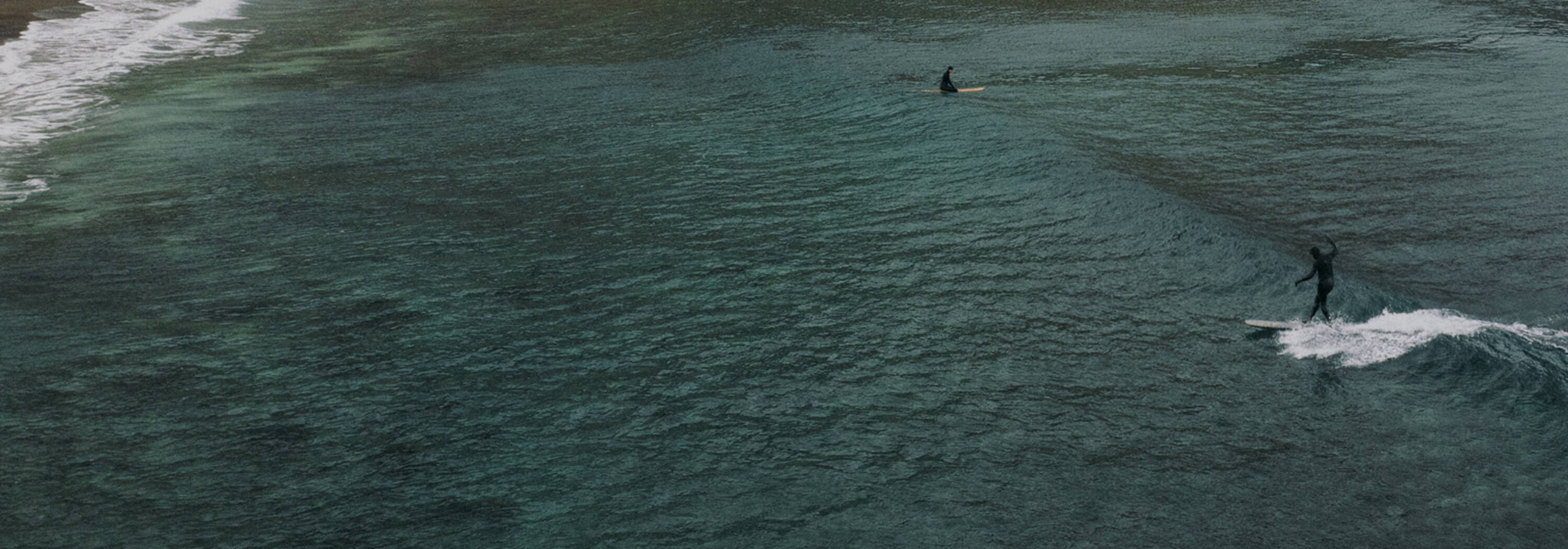 Surfers in the Arctic Ocean off the coast of Iceland