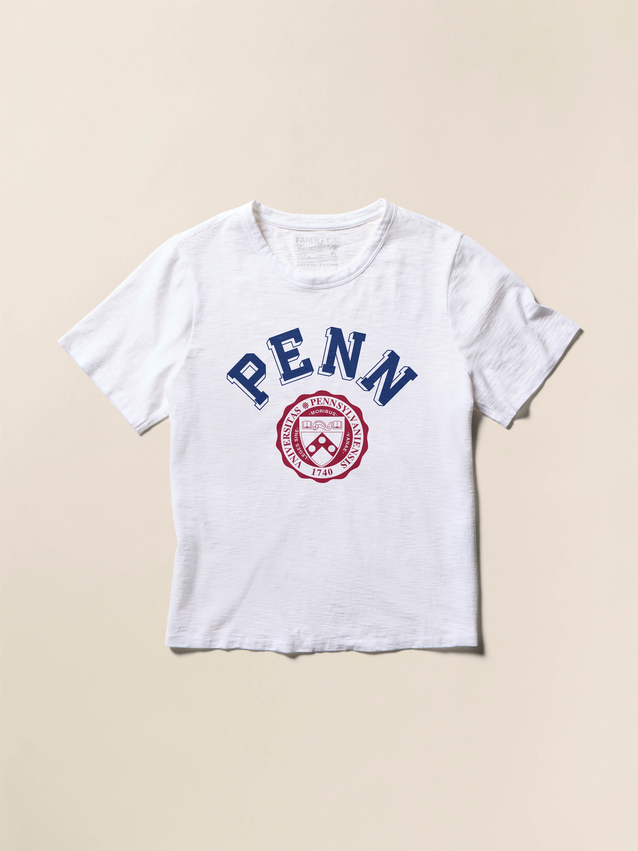 White short sleeve t-shirt with University of Pennsylvania graphic on the front against a beige background