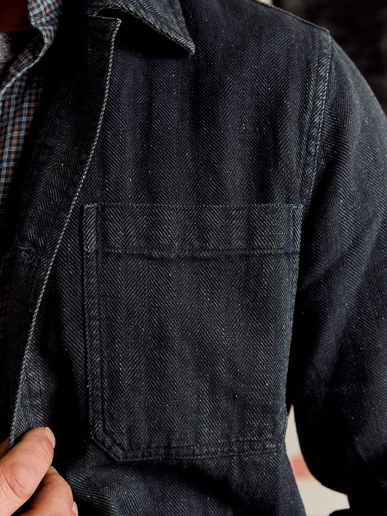 A close up of the indigo herringbone studio jacket