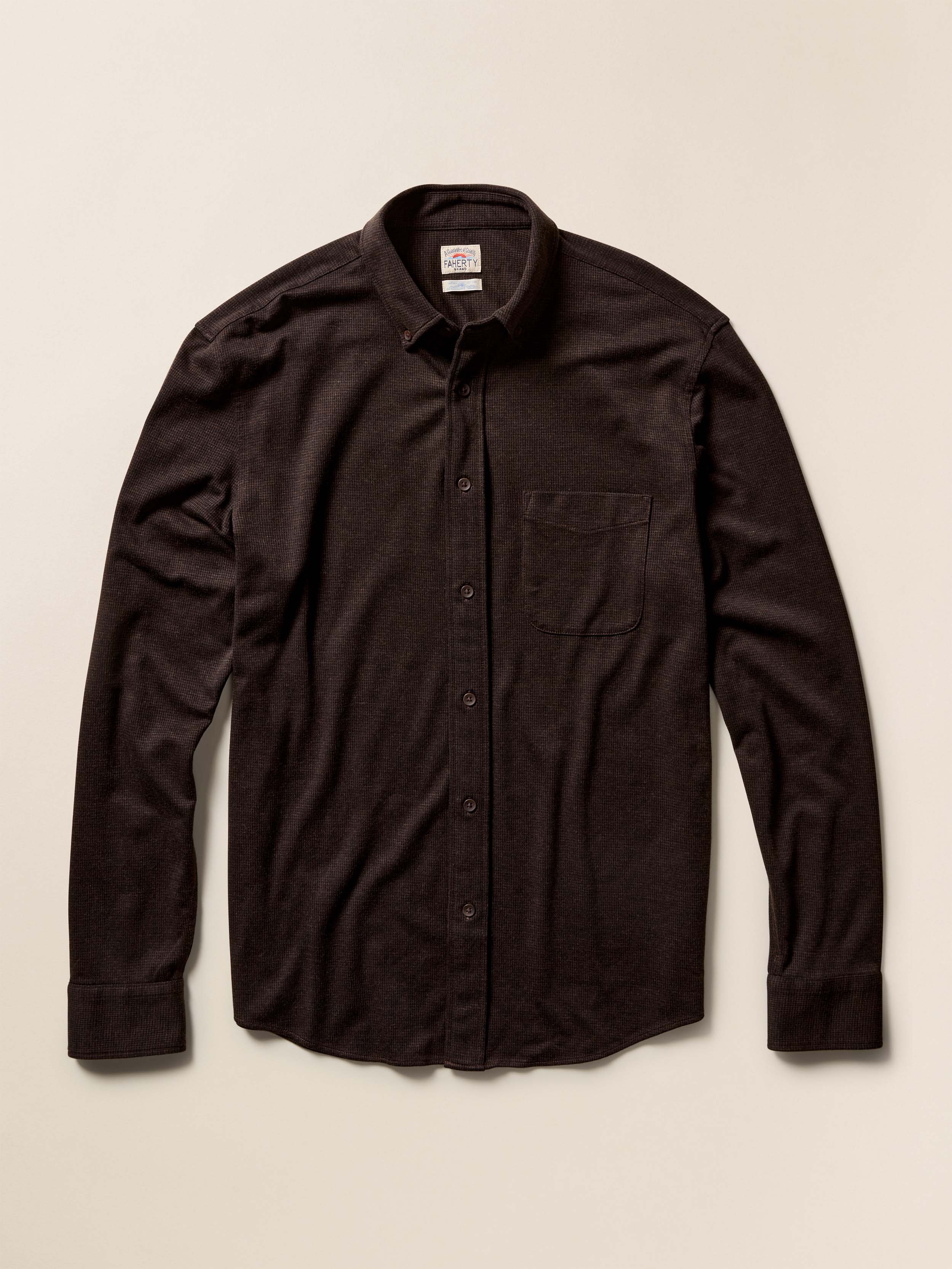 Dark brown button-up shirt on a beige background