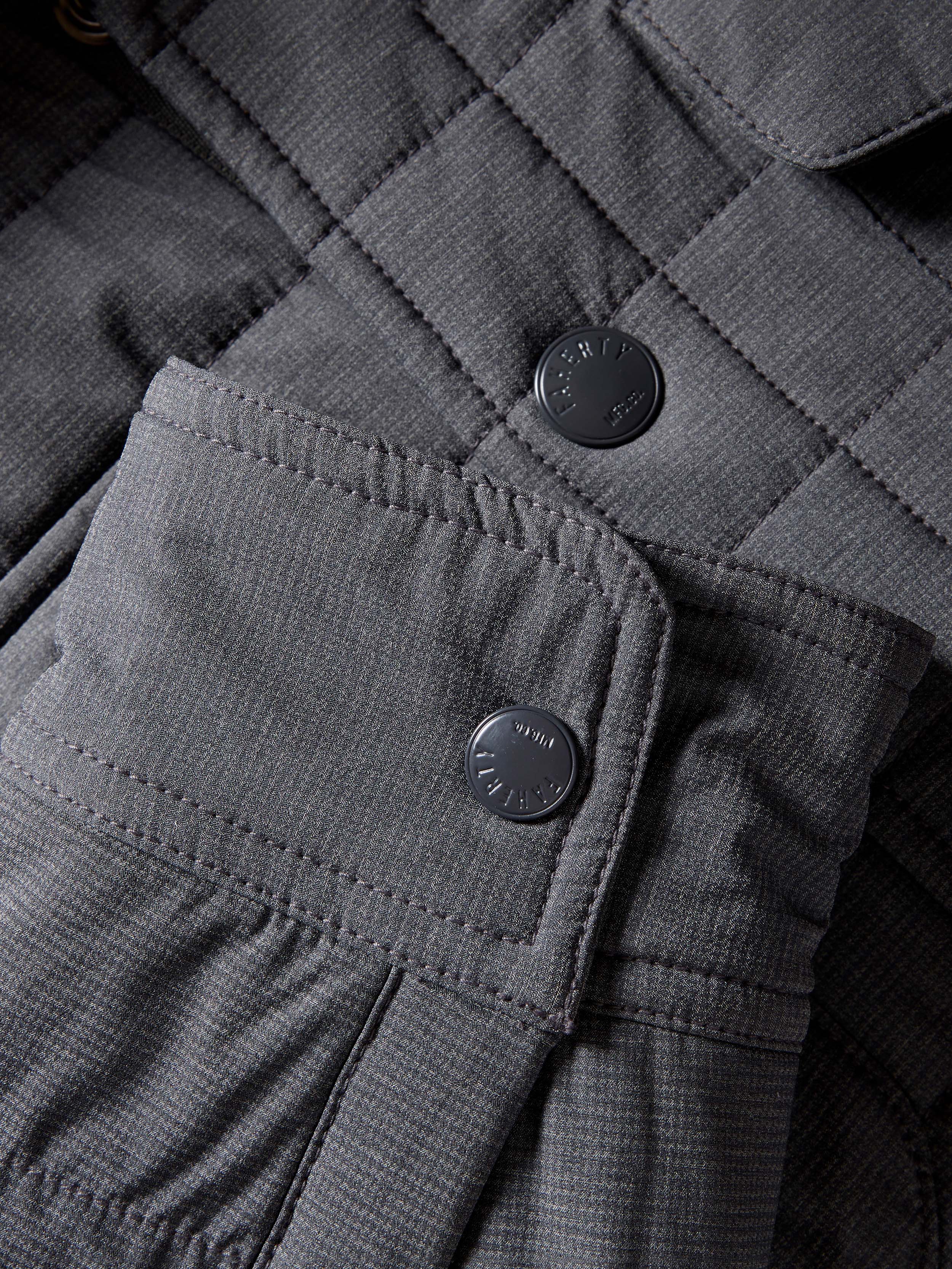 Gray quilted jacket on a beige background