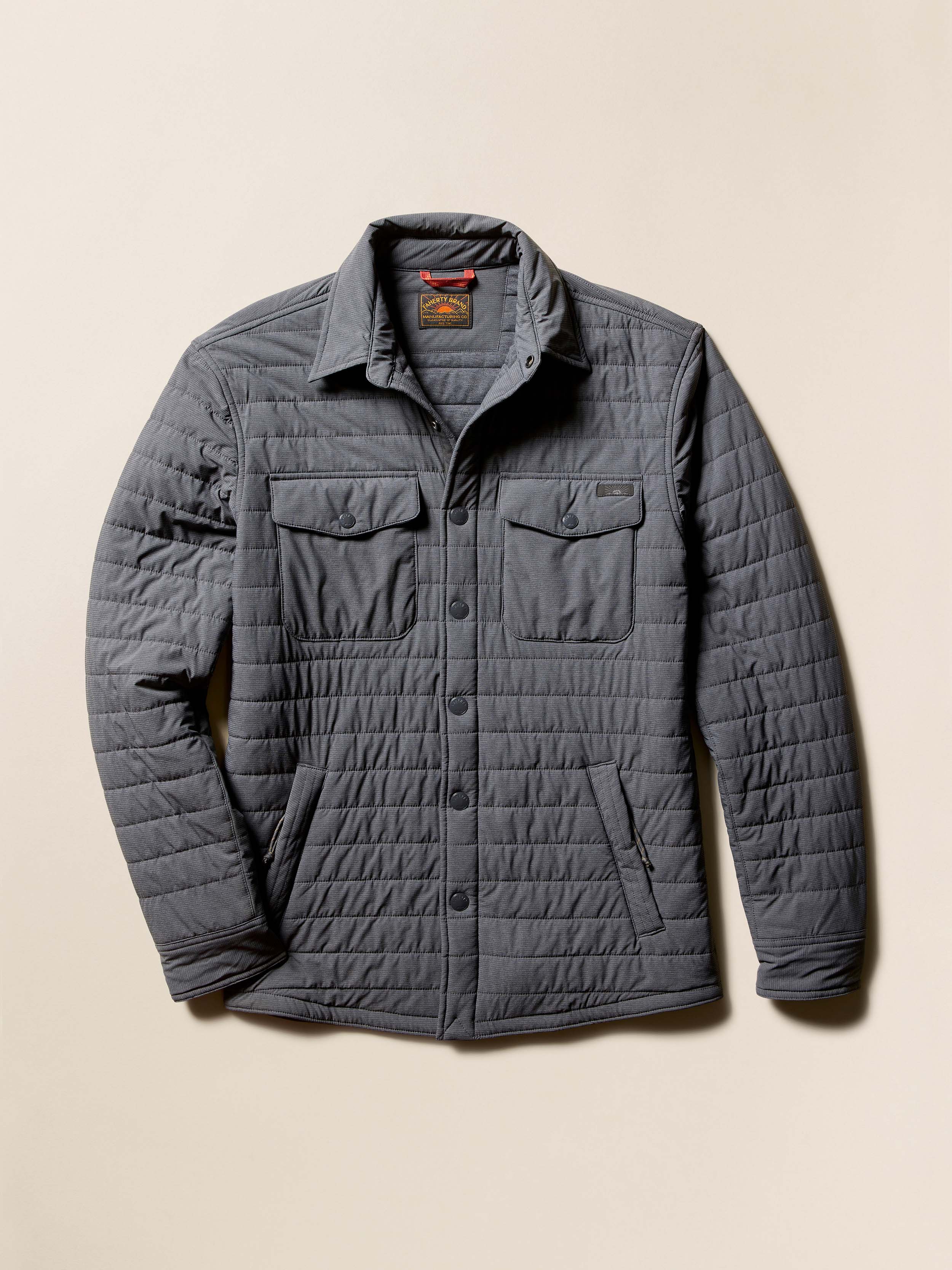 Gray quilted jacket on a beige background