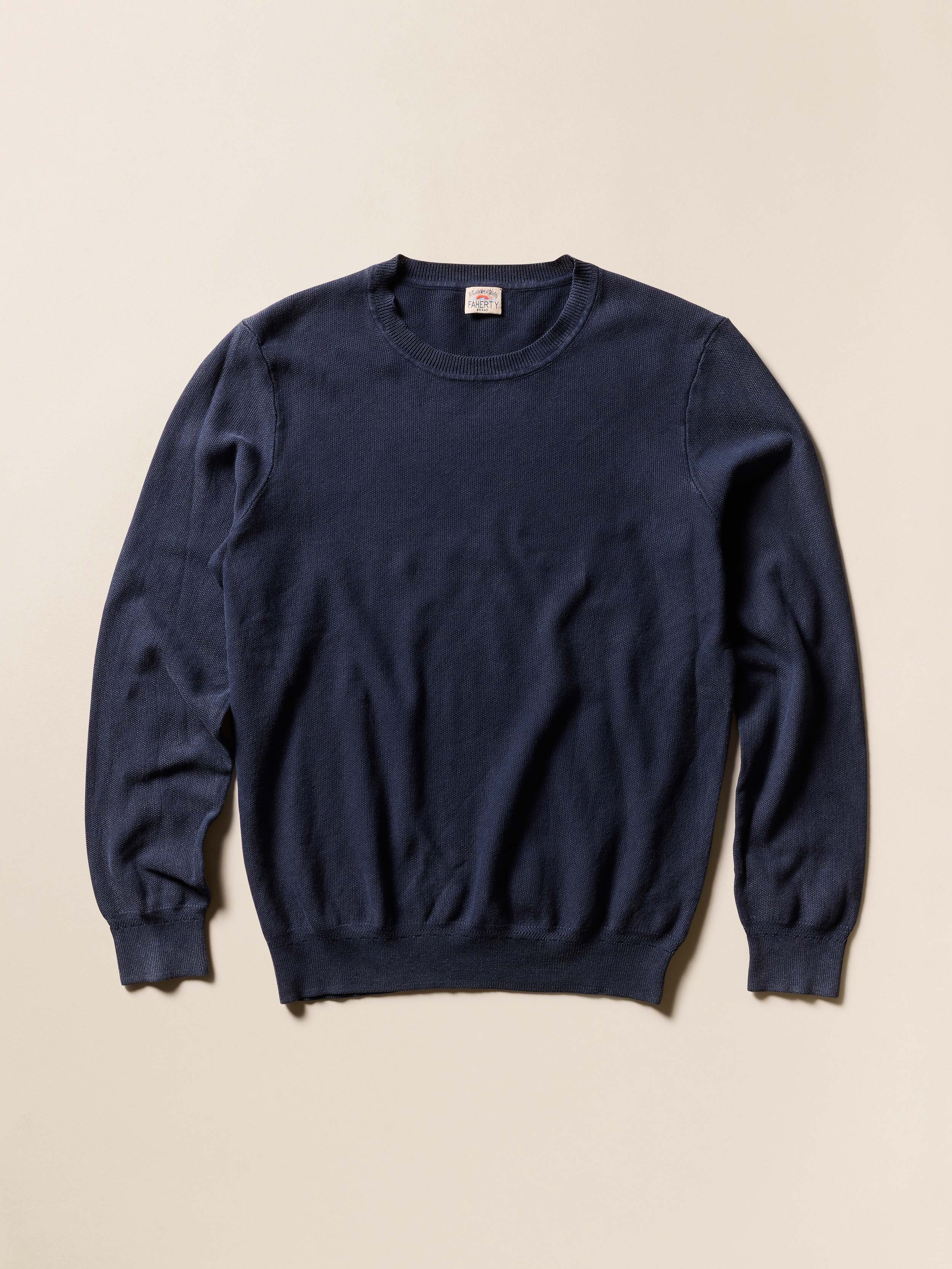 Navy blue sweater on a beige background