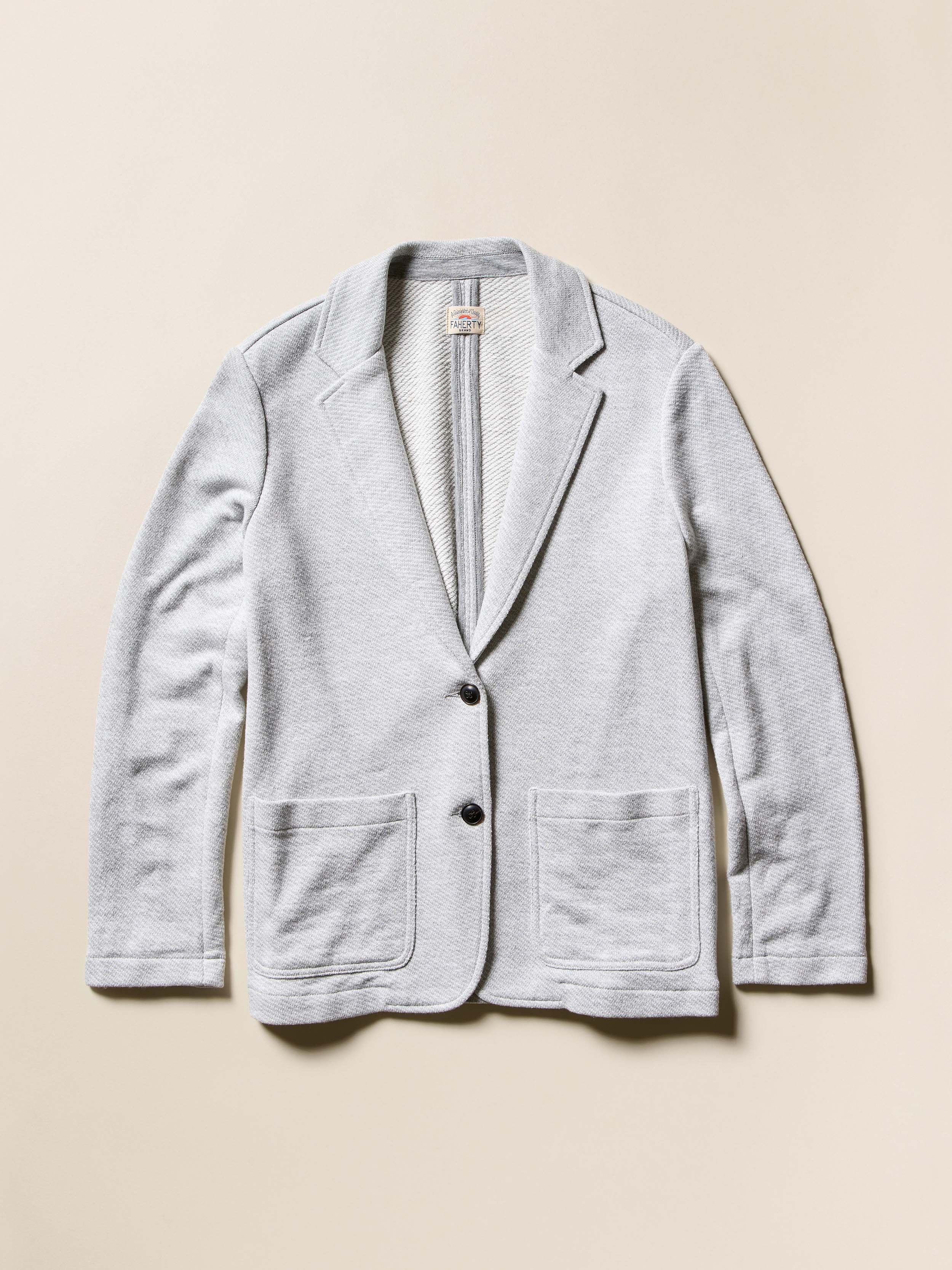 Light gray blazer against a beige background