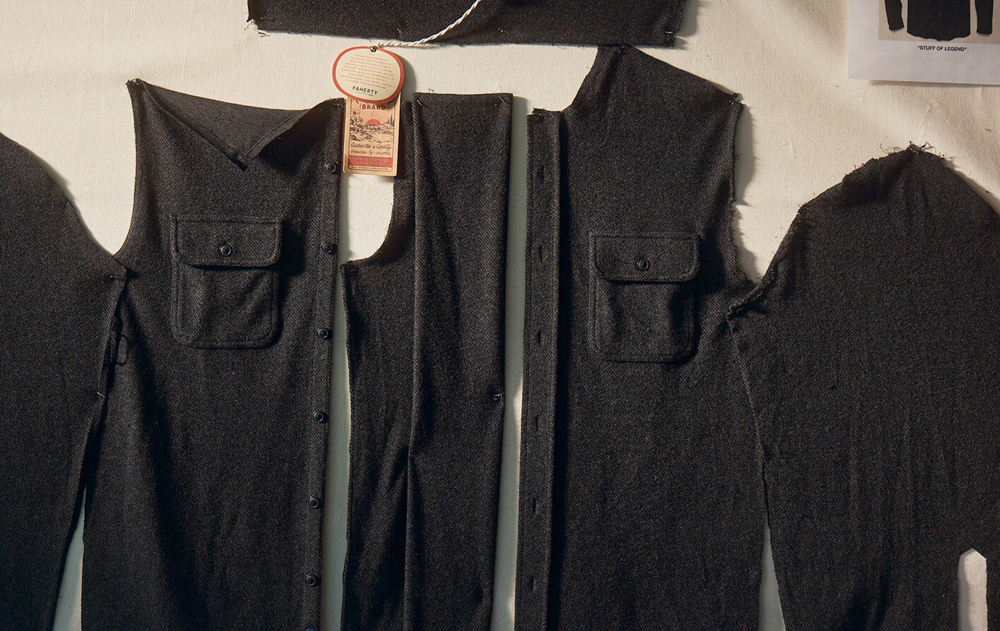 a legend sweater shirt cut into pattern pieces hanging on a moodboard in a design studio