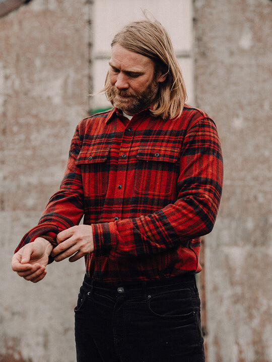 Man rolling up the cuff of his legend sweater shirt