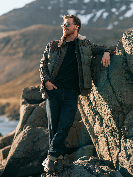 Man smiling in the sunlight with his hand in the pocket of his stretch terry pants