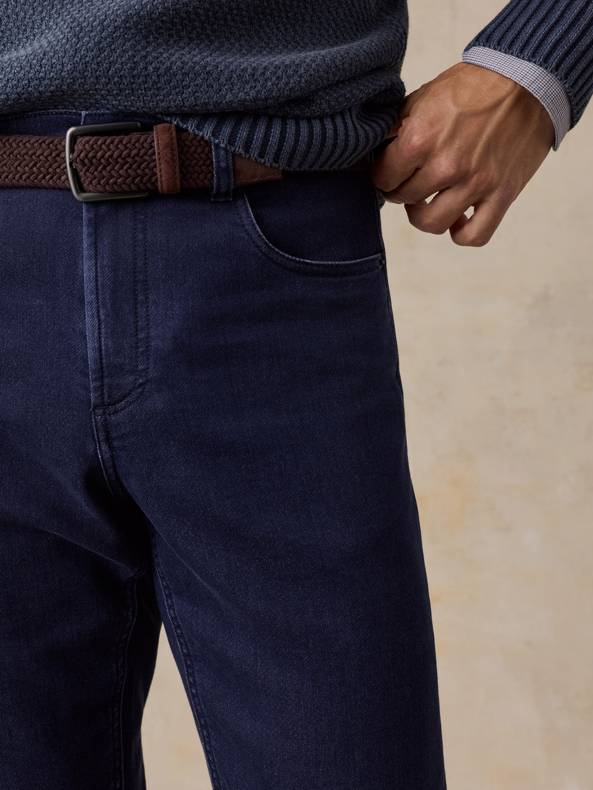 Close up of a man wearing blue jeans with a brown belt, image 3 of 5