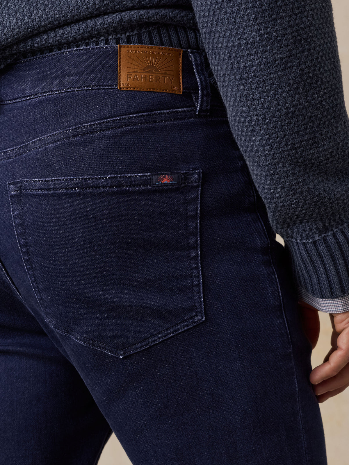 Close up of a man viewed from behind wearing blue jeans, image 4 of 5