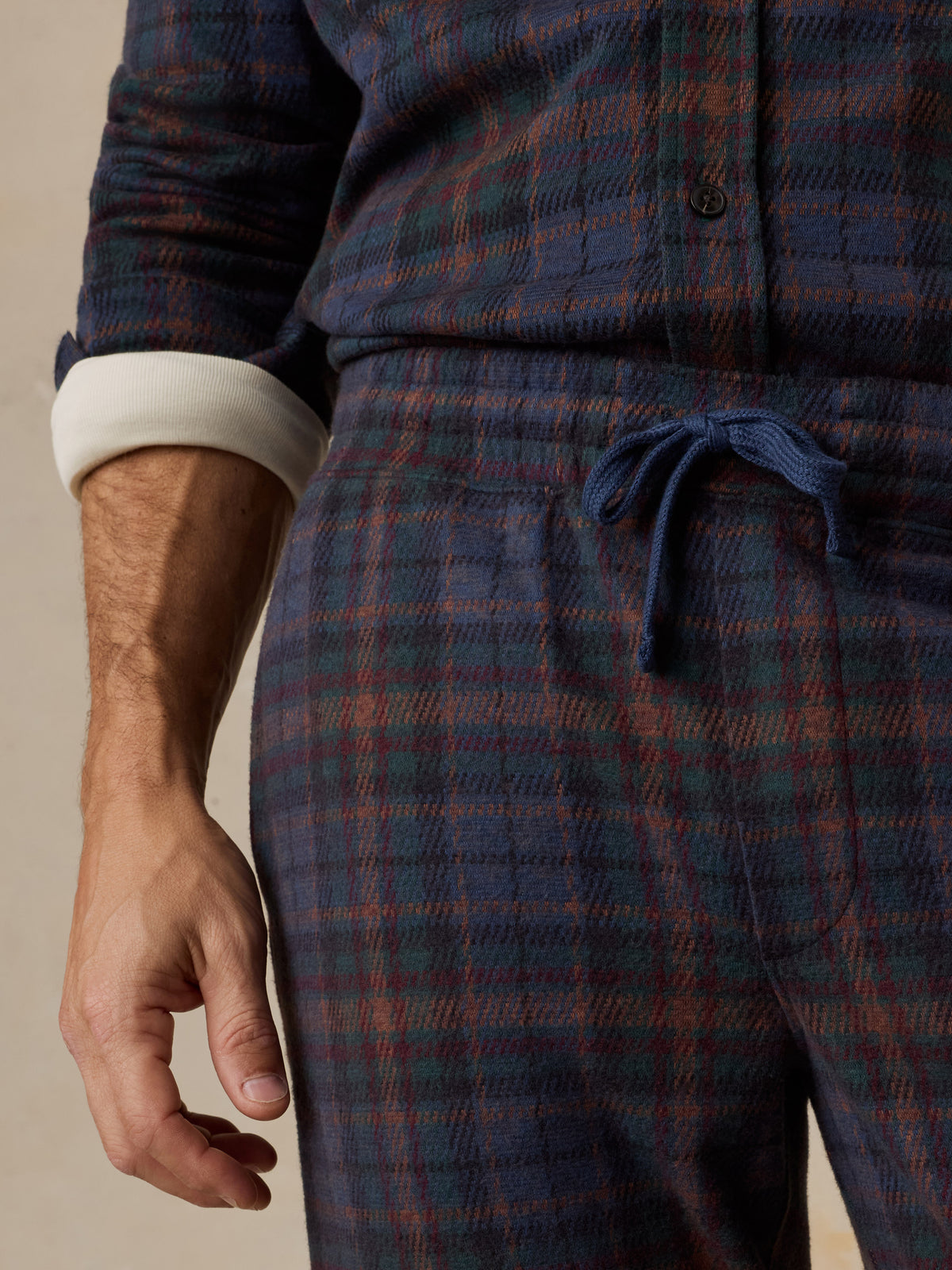 Close up of a man wearing a plaid lounge set, image 5 of 6