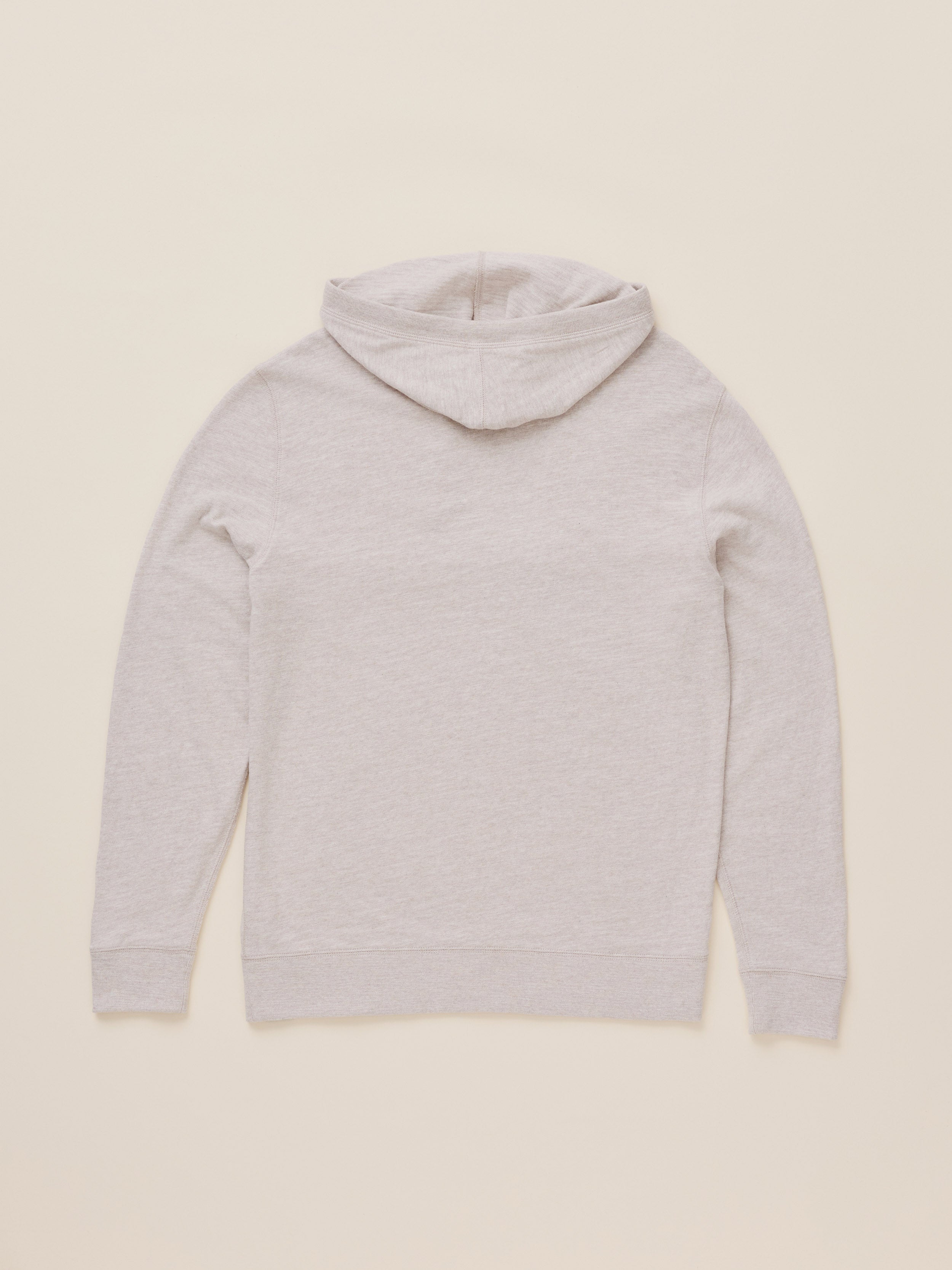 A light heather gray pullover hoodie shown from the back, laid flat against a solid cream-colored background.