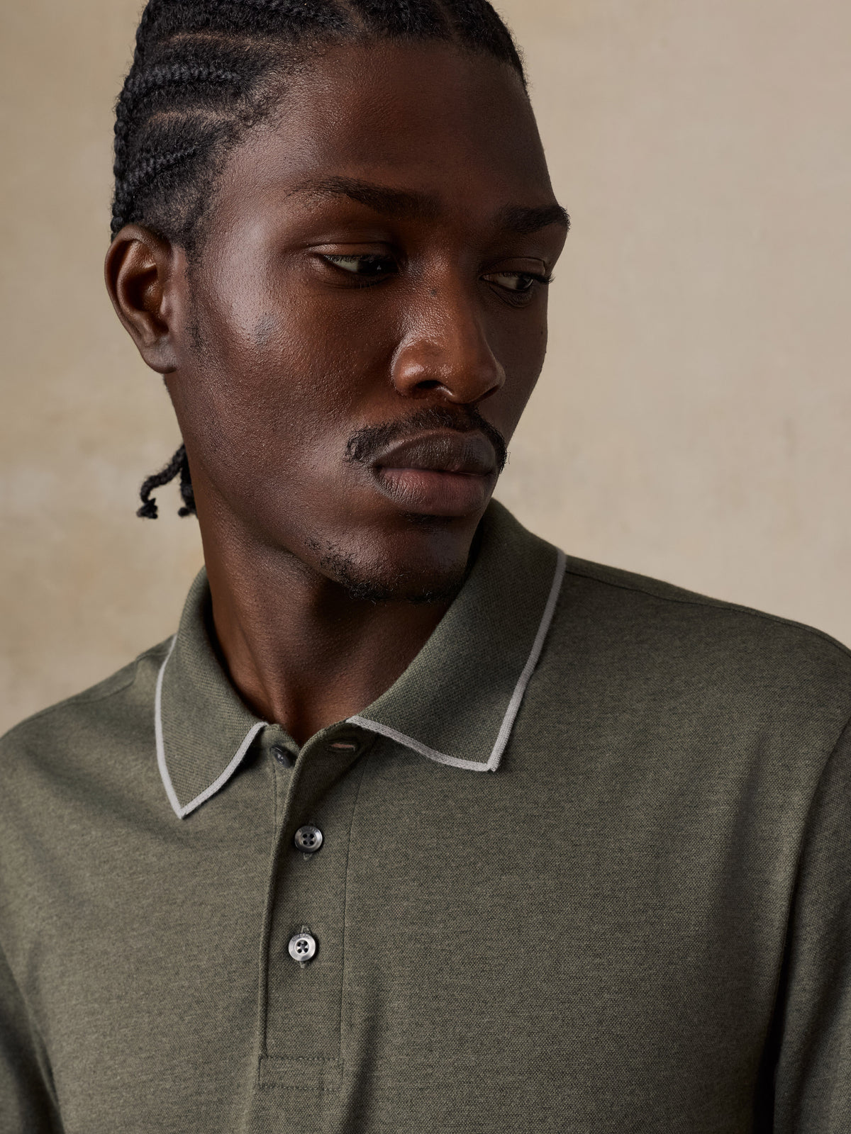 Close up of a man wearing a green long sleeve polo, image 4 of 6