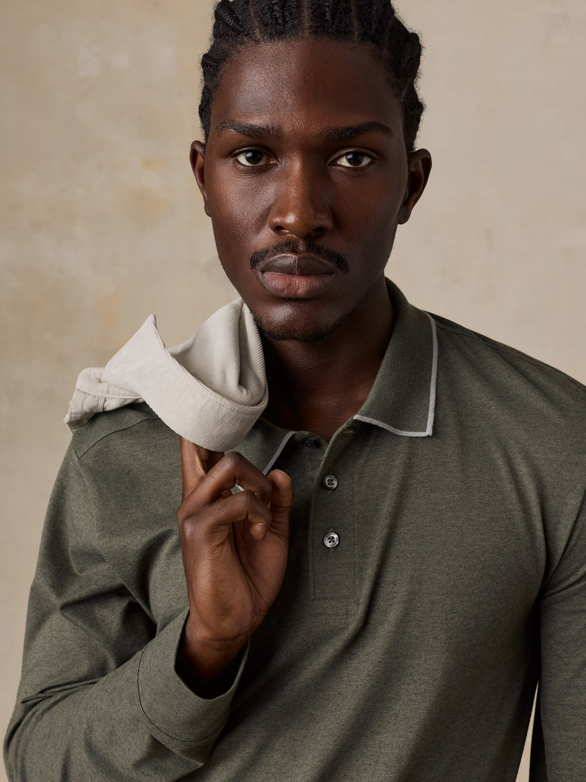 Close up of a man wearing a green long sleeve polo, image 3 of 6