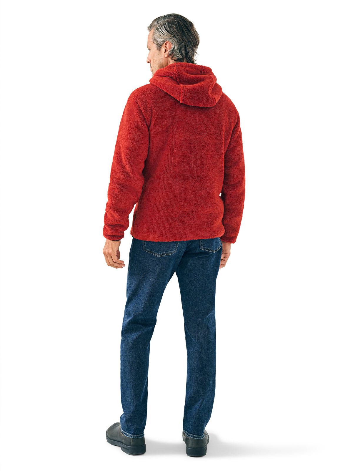 A man viewed from behind wearing a red hoodie and blue jeans, image 2 of 2
