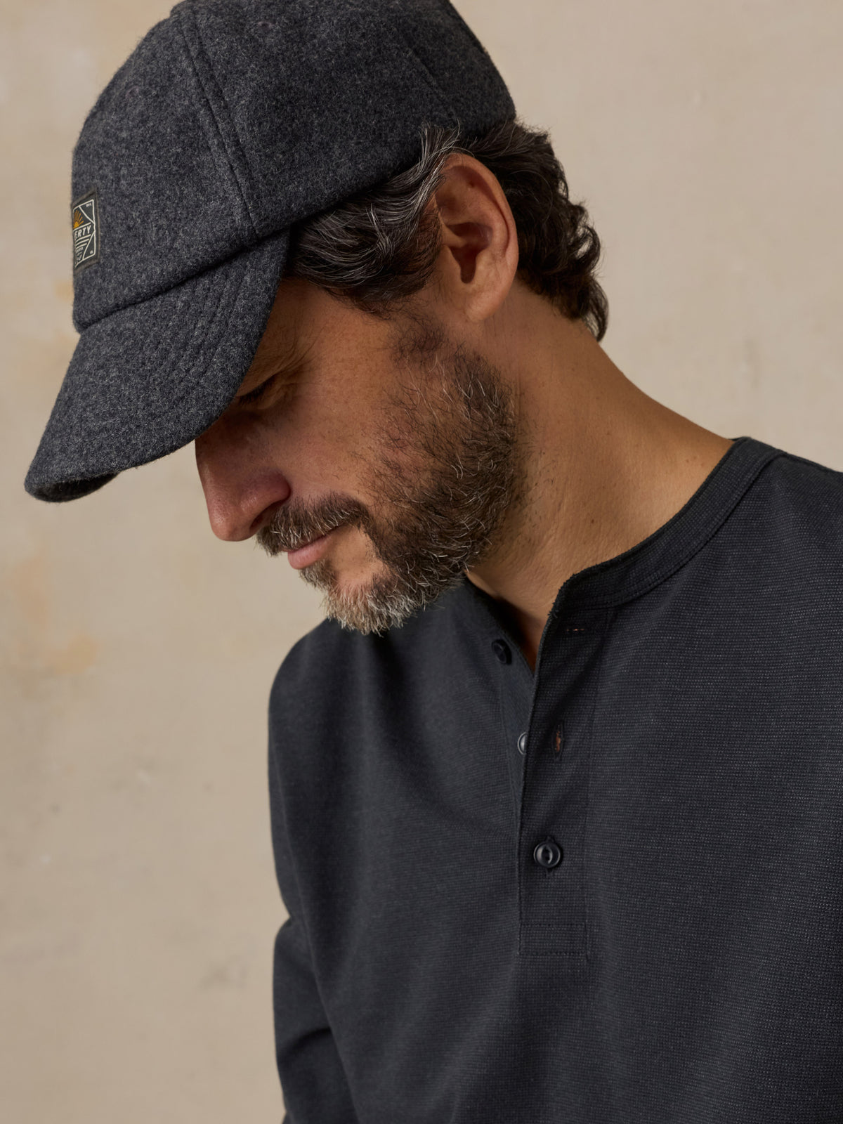 Close up of a man wearing a black henley , image 4 of 6