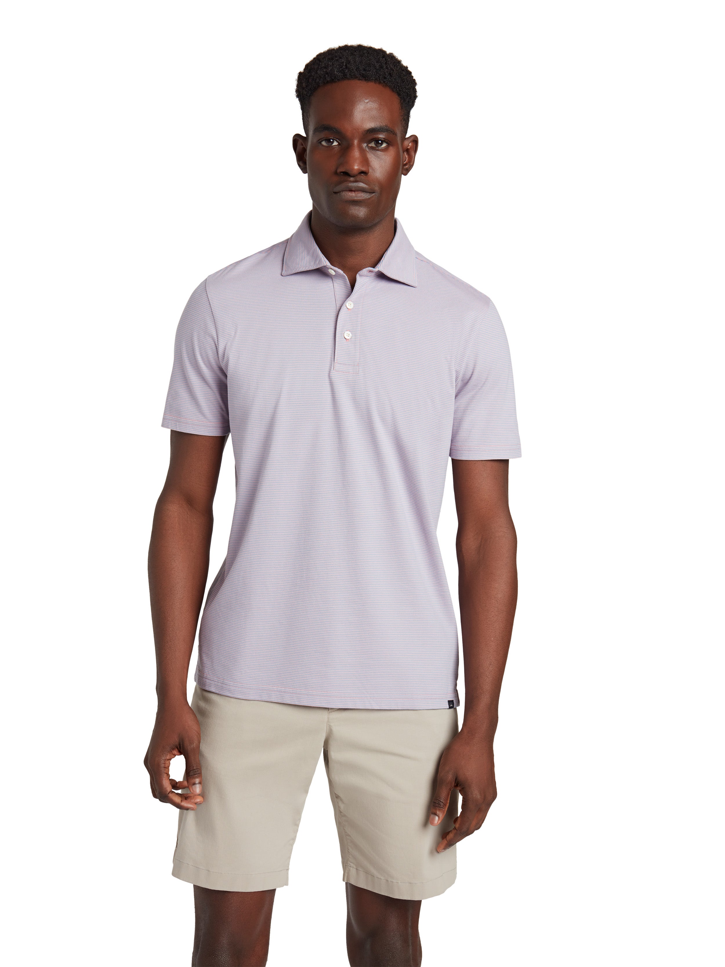 A man wearing a lavender polo and beige shorts