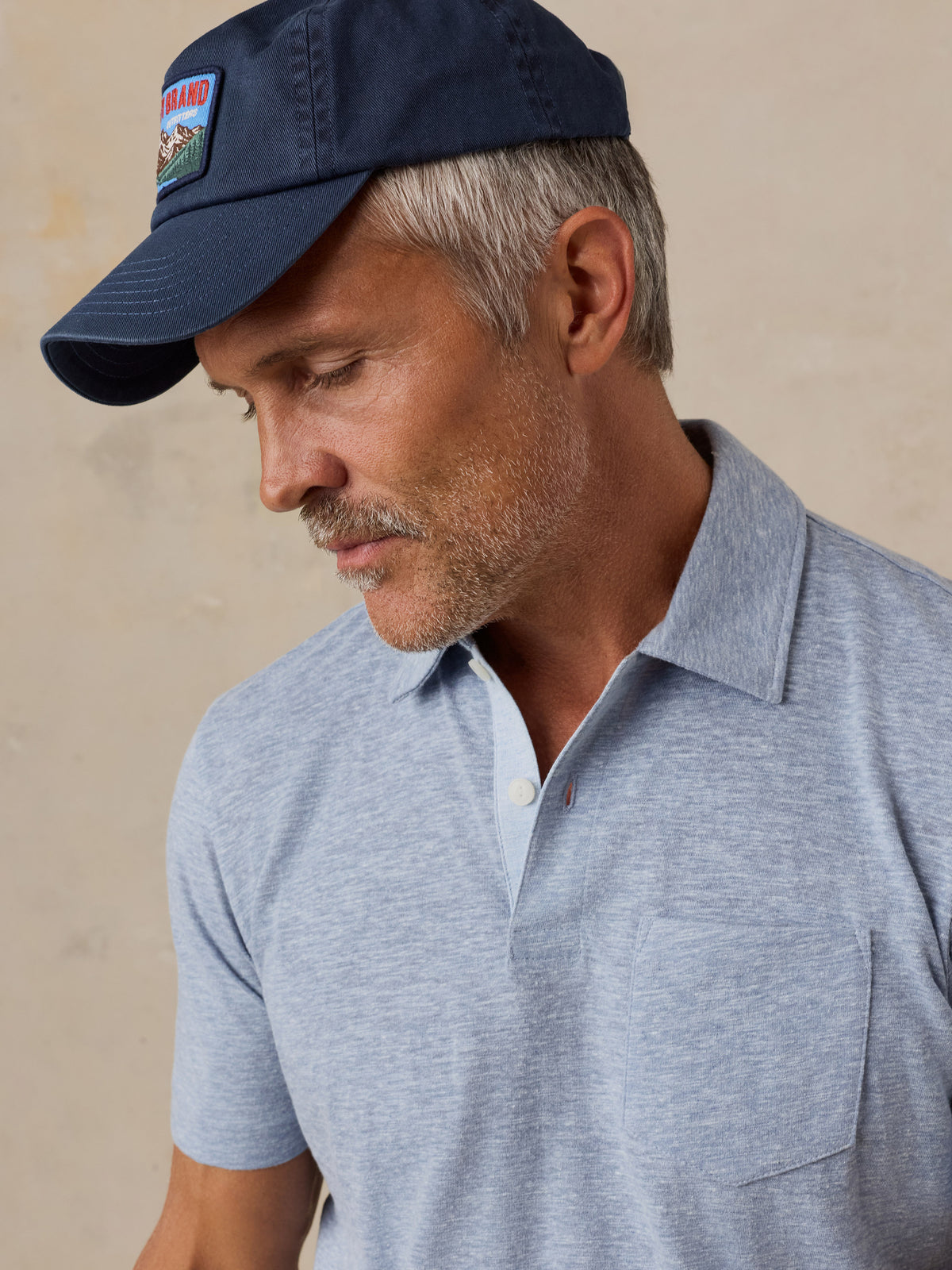 Close up of a man wearing a light blue polo, image 3 of 5