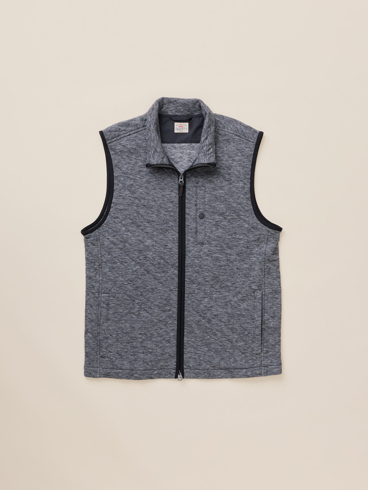 A sleeveless zip-front vest in heathered dark gray with black trim along the collar, armholes, and zipper, laid flat against a light beige background., image 6 of 7