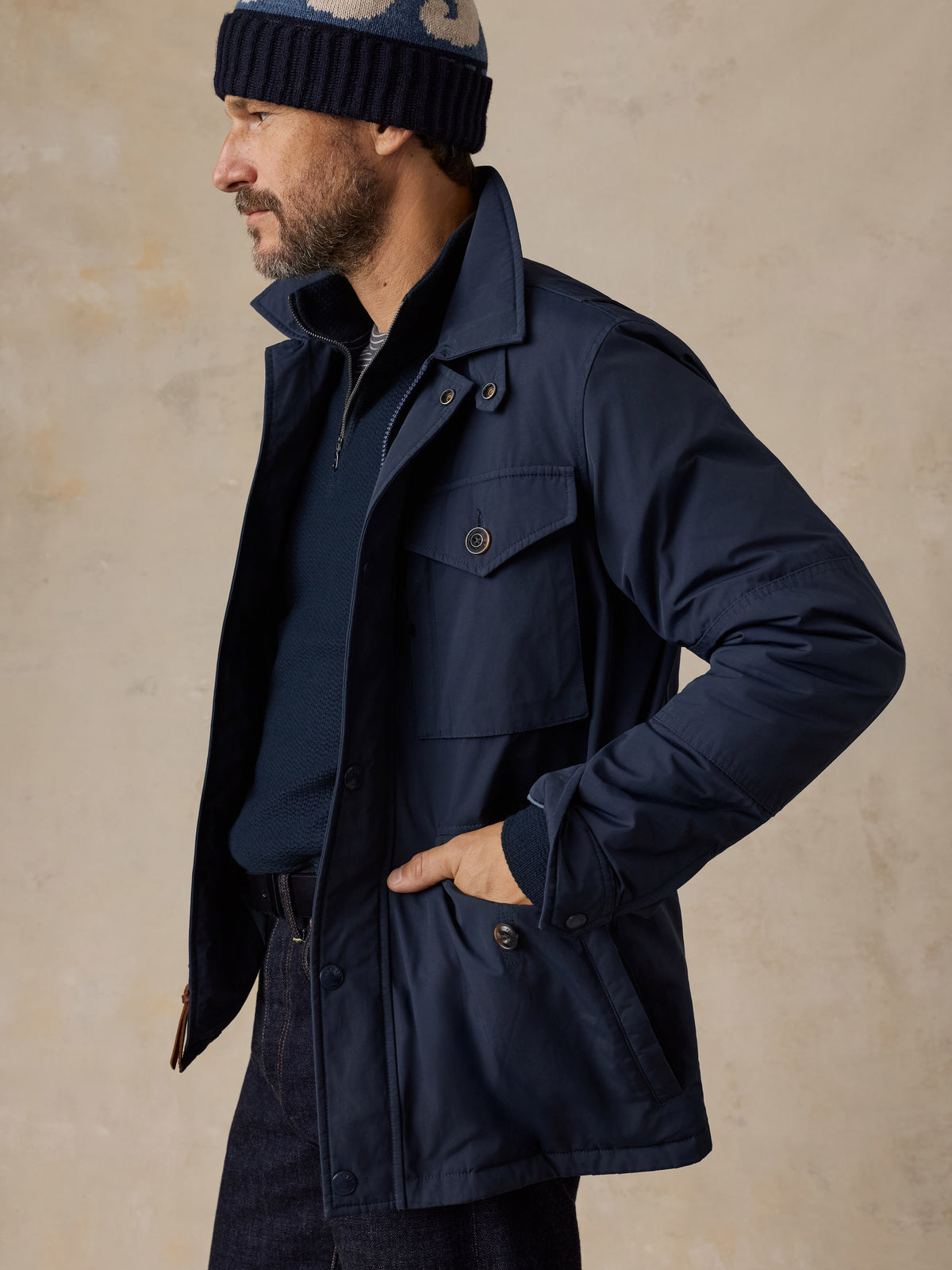 A man wearing a blue jacket and blue jeans, image 5 of 5