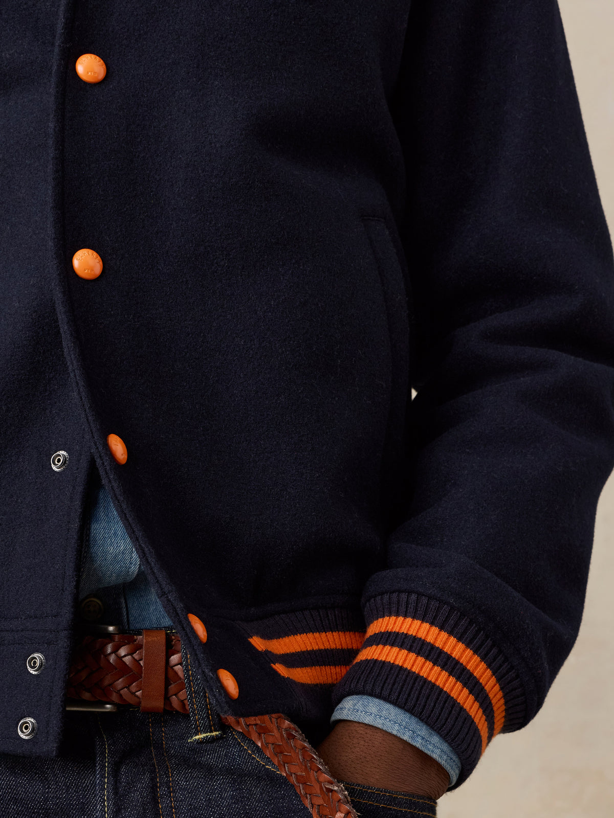 Close up of a man wearing a NY Knicks varsity jacket, image 4 of 8