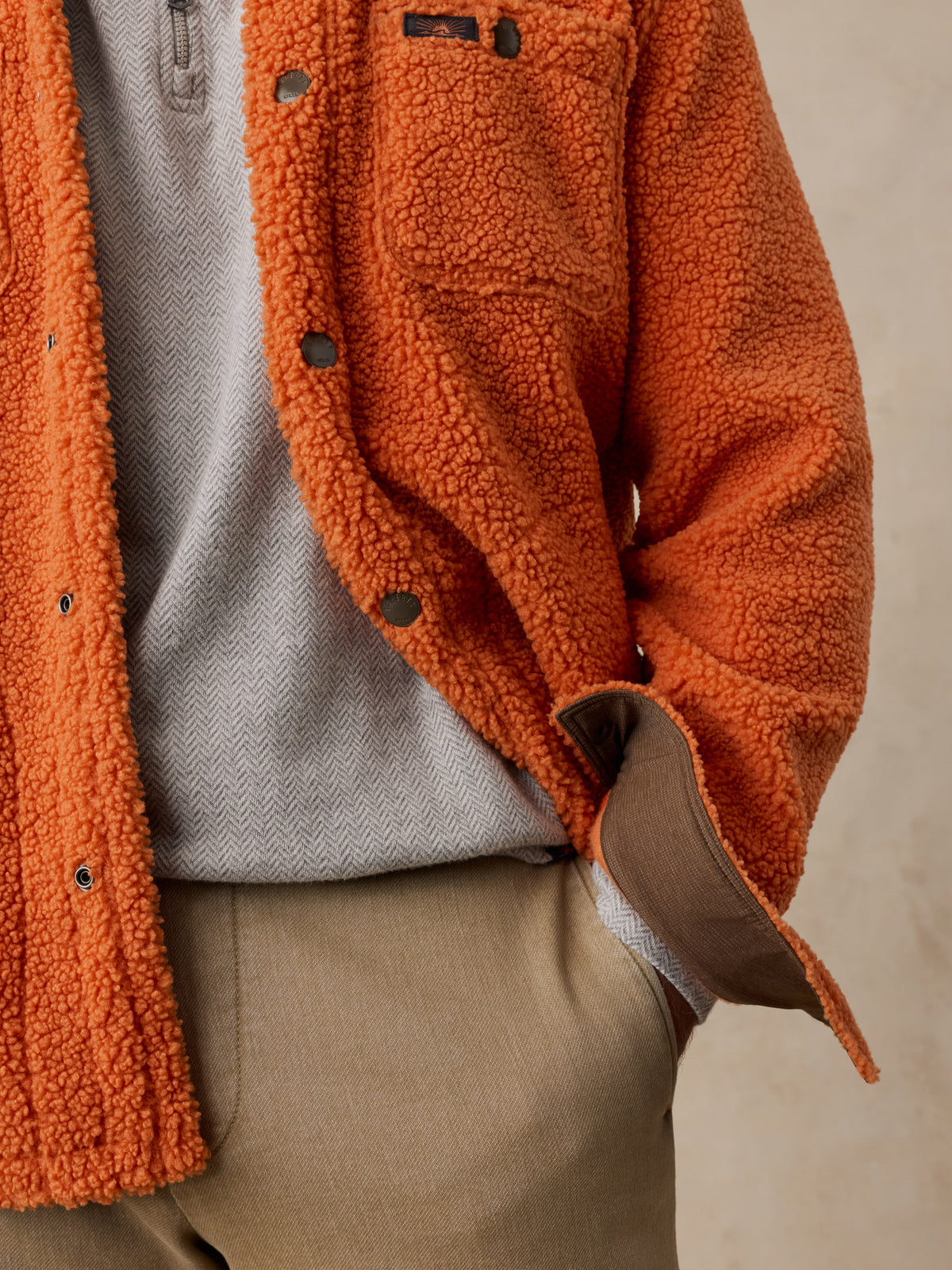 Close up of a man wearing an orange fleece , image 4 of 6