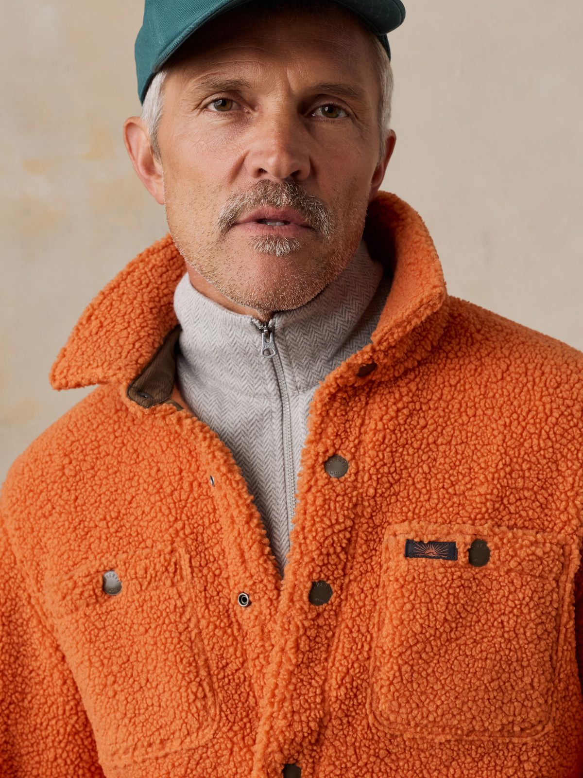 Close up of a man wearing an orange fleece , image 5 of 6