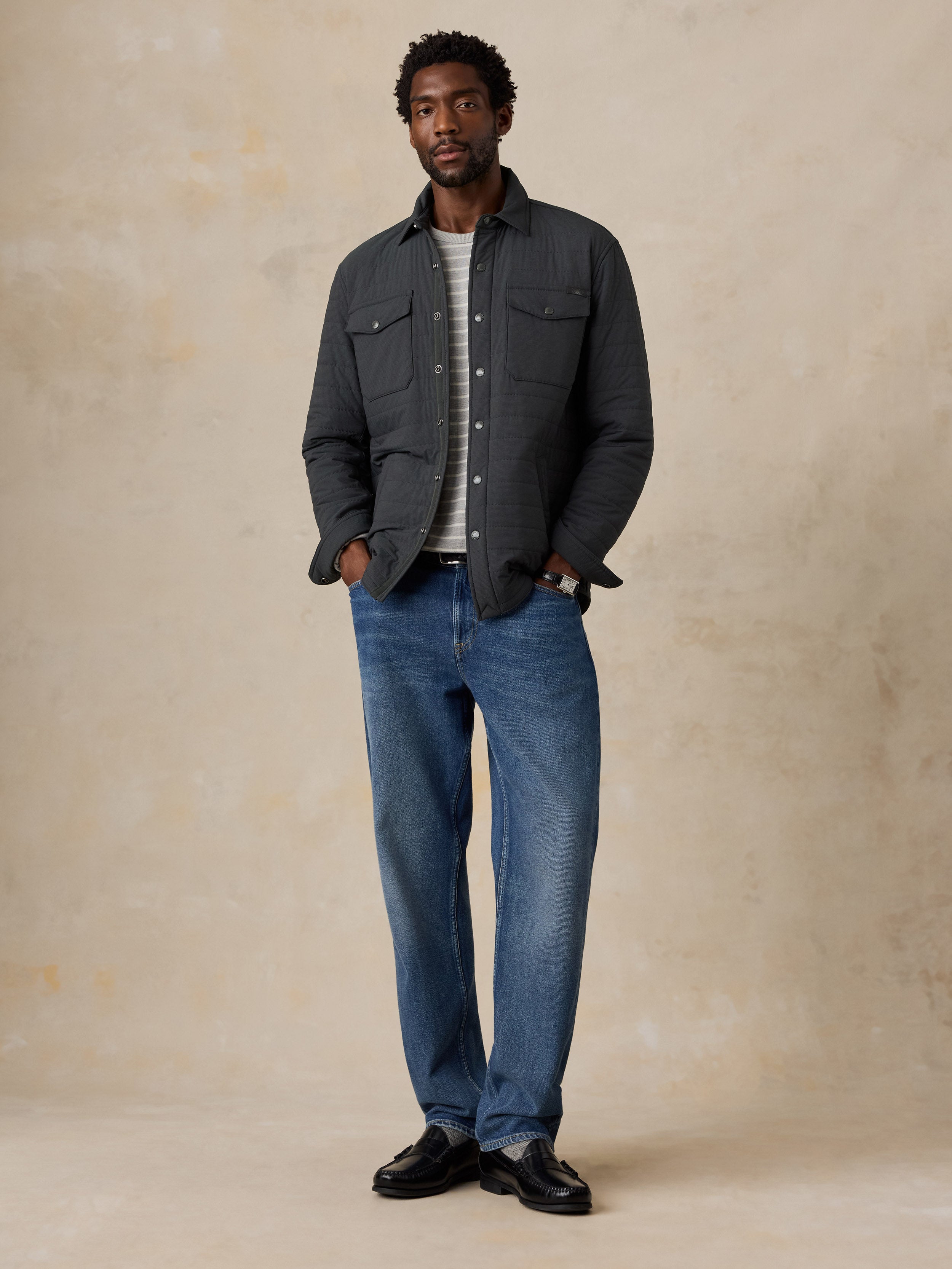 A man wearing a black jacket and jeans