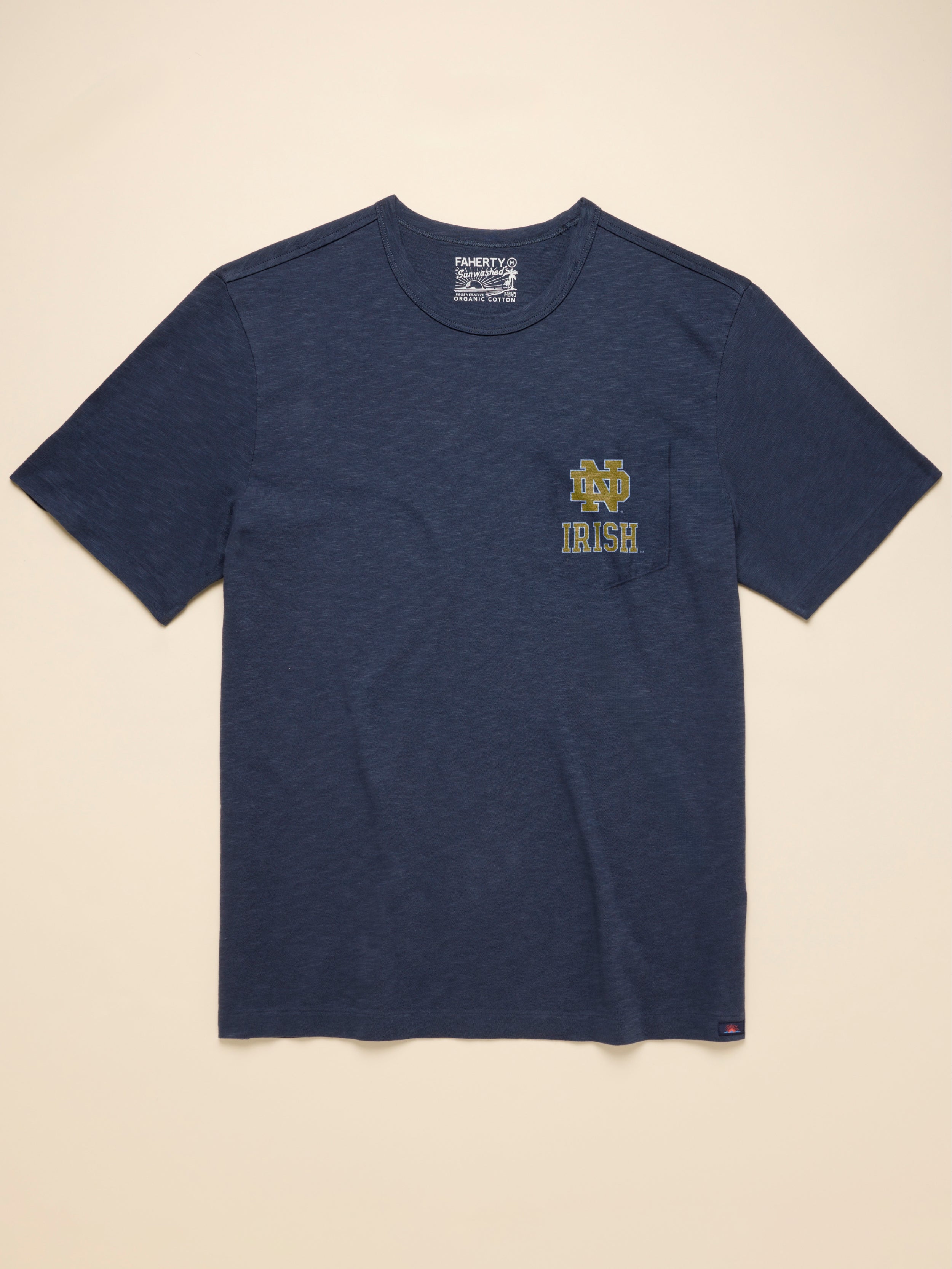 Navy blue t-shirt with a Notre Dame logo on the chest against a beige background