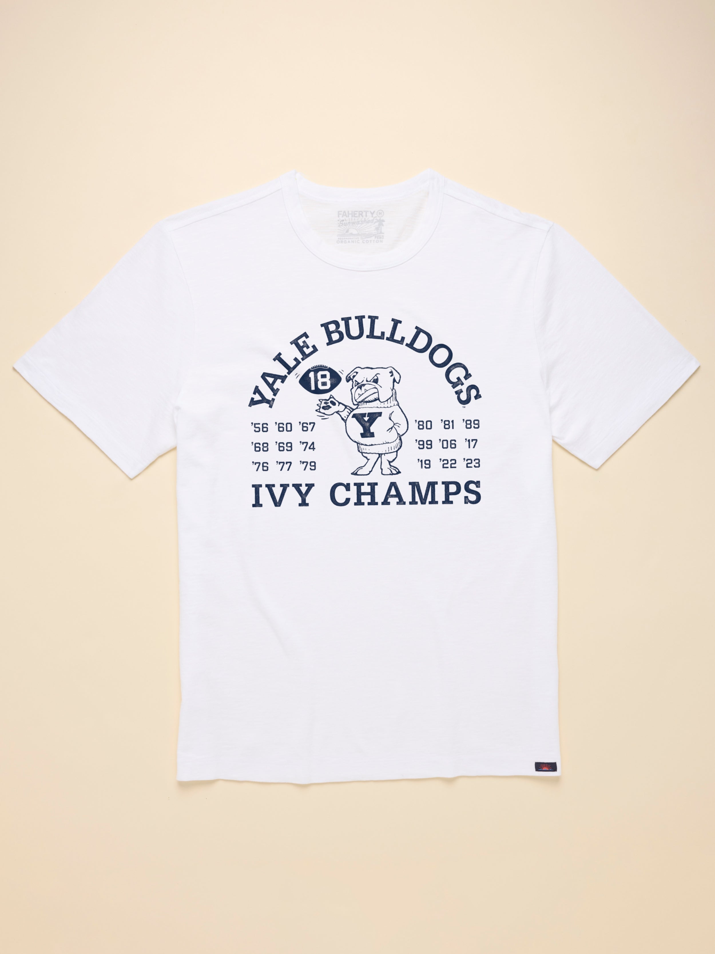 White t shirt with Yale graphic on the front against a beige background