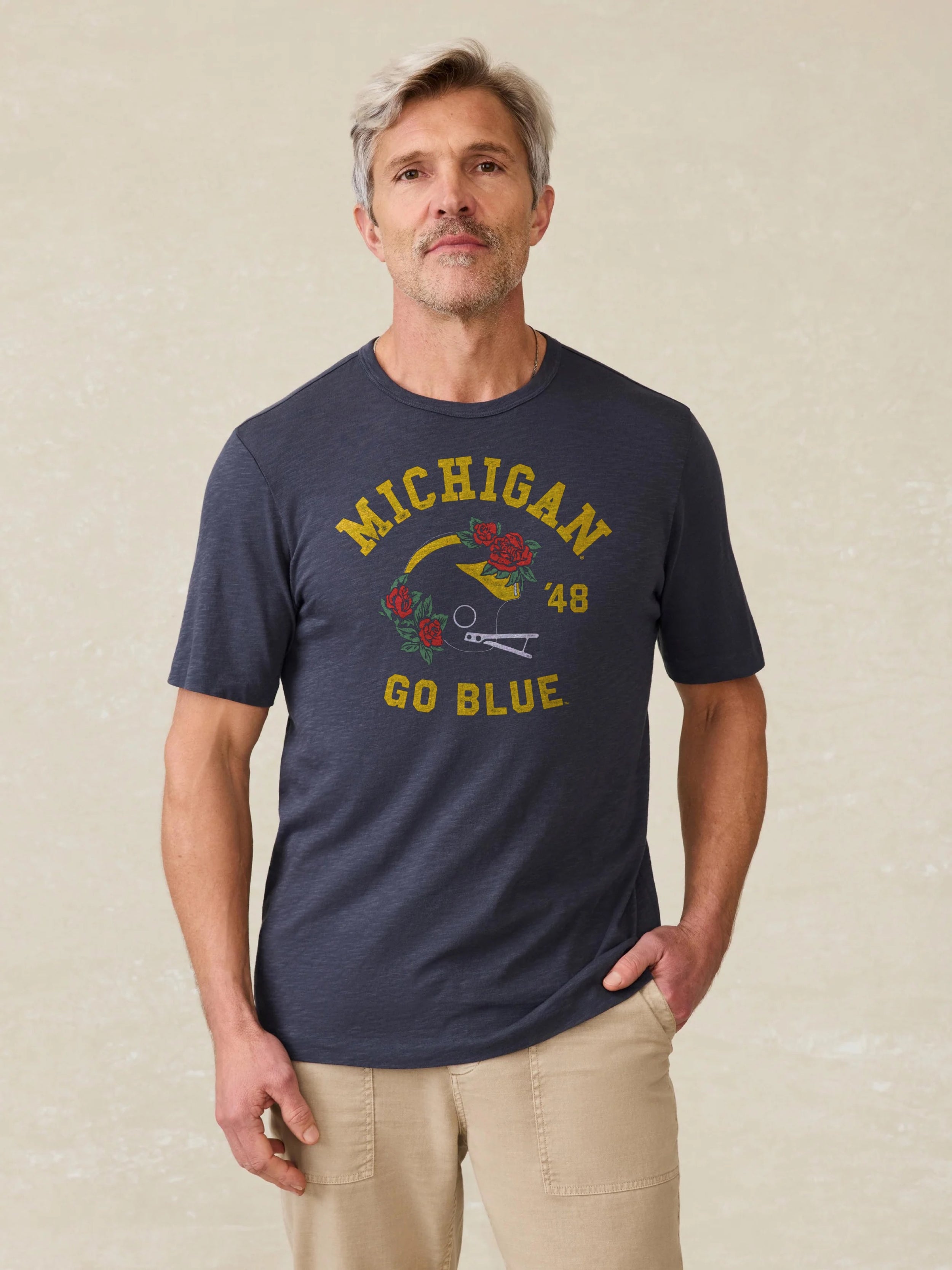 Navy t-shirt with Michigan graphic against a beige background