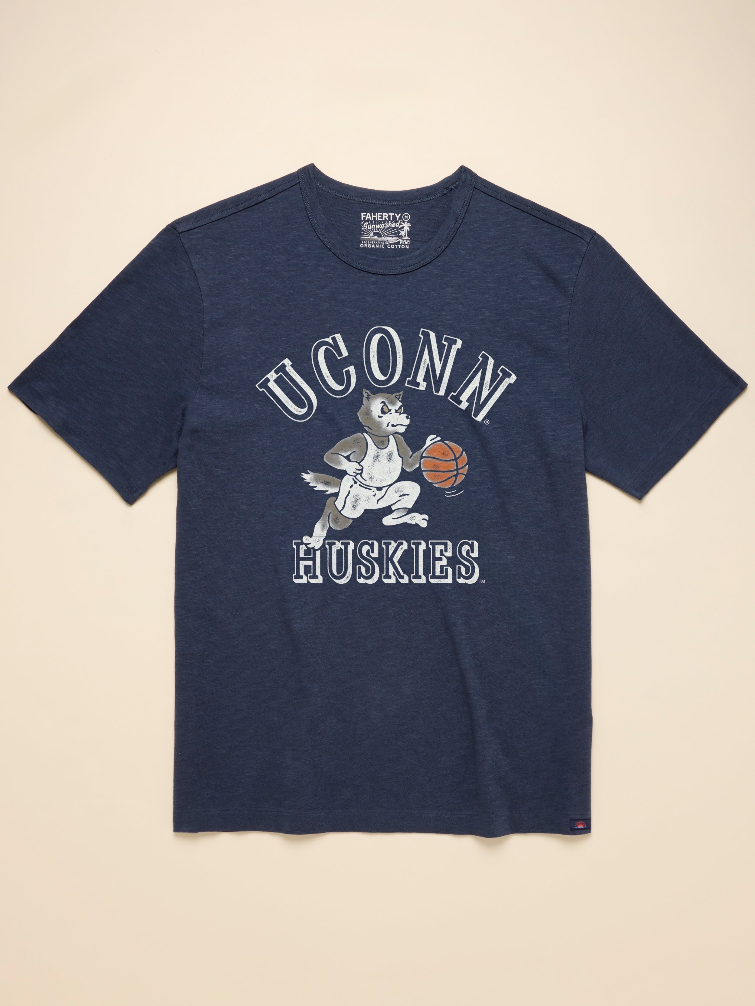 Navy blue t-shirt with UConn Huskies graphic on the center front against a beige background