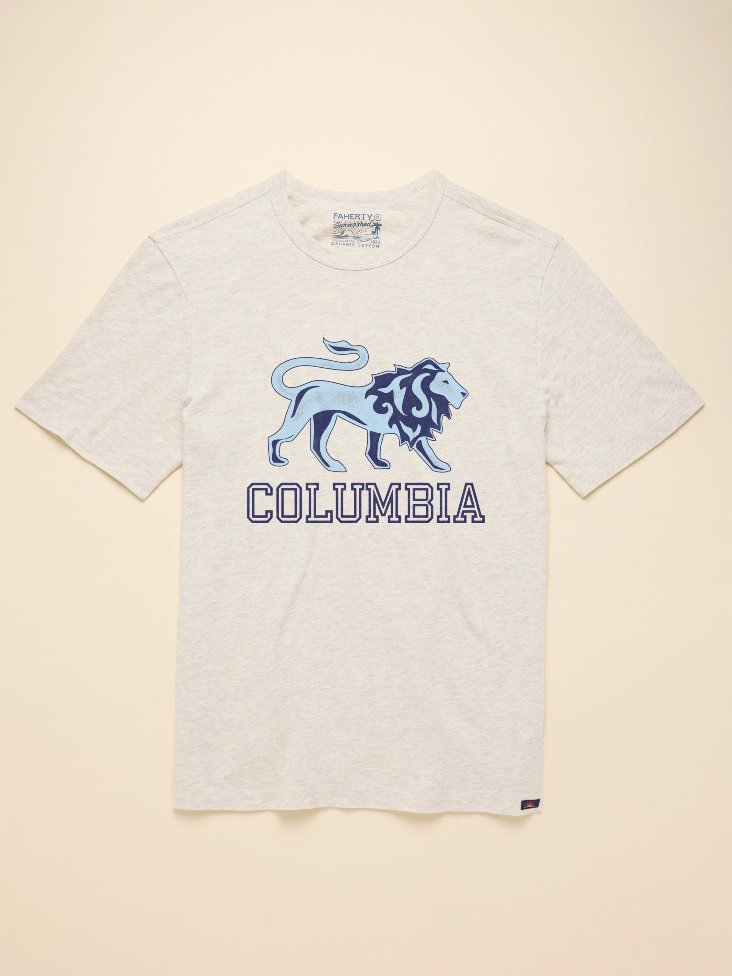An ivory heather t-shirt with Columbia graphic at the front against a beige background