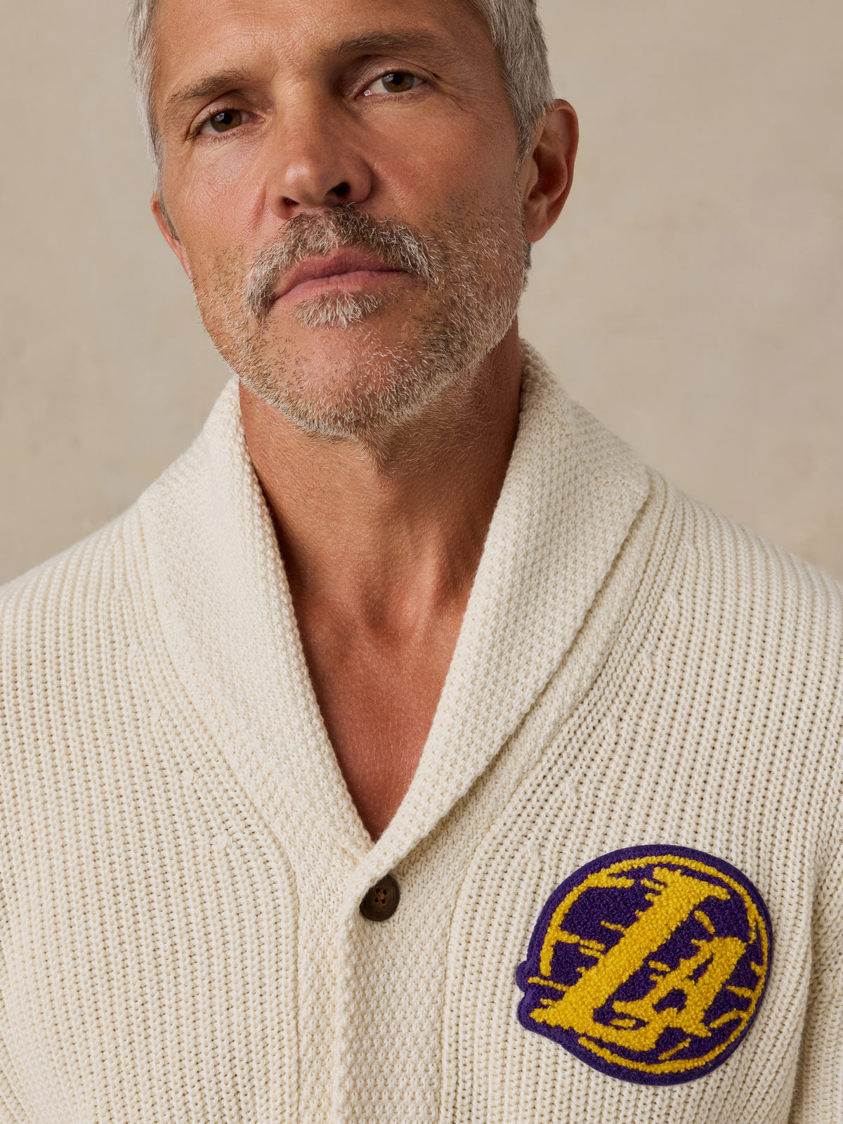 Close up of a man wearing an off-white LA Lakers cardigan, image 3 of 7