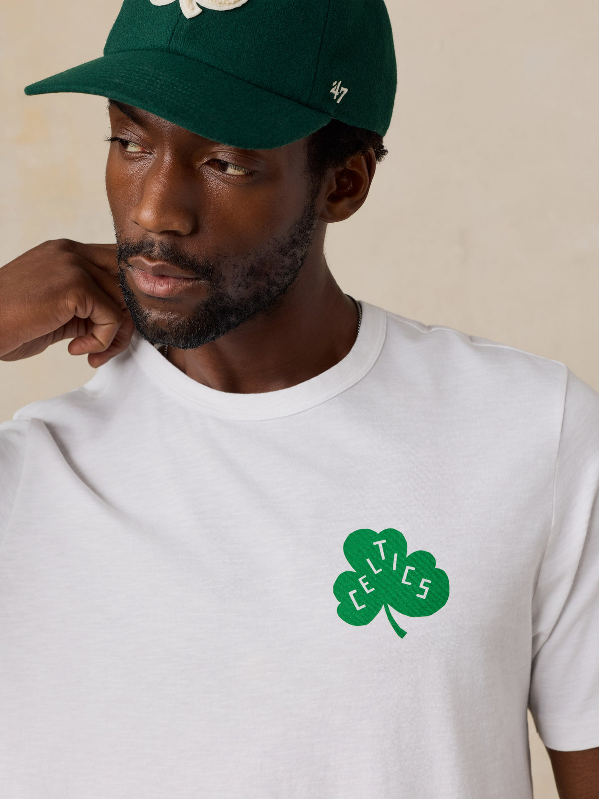 Close up of a man wearing a white Boston Celtics tee, image 6 of 6