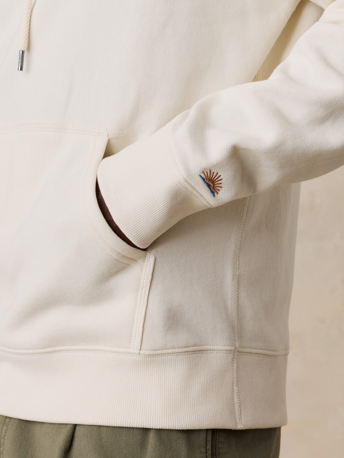 Close up of a man wearing a white Boston Celtics hoodie, image 4 of 6